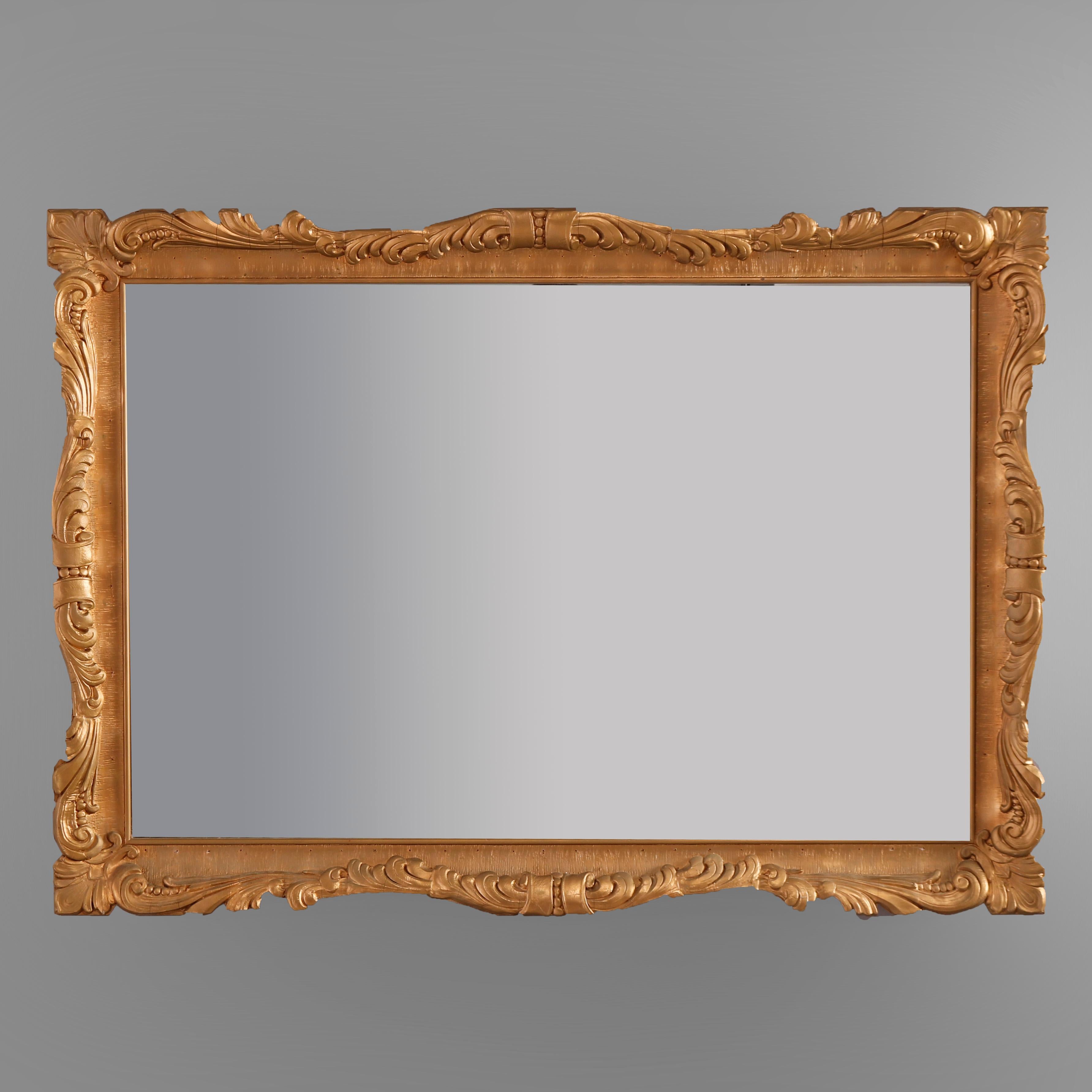 An antique French Louis XIV style wall mirror offers giltwood frame with foliate and scroll elements, c1920

Measures - 34.25