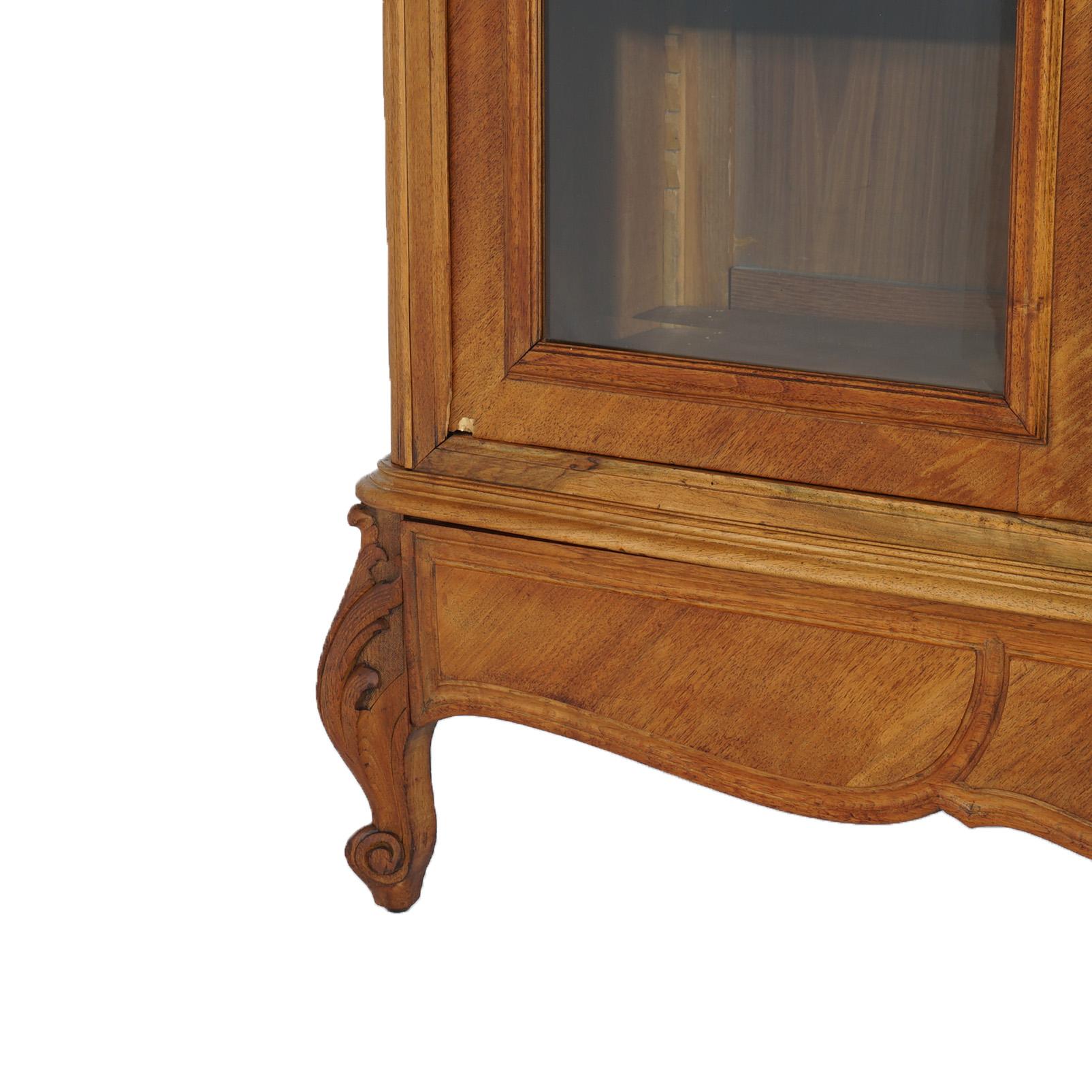 ***Ask About Reduced In-House Delivery Rates - Reliable Professional Service & Fully Insured***
An antique French Louis XIV style curio Wardrobe offers kingwood construction with arched crest over case with double glass doors opening to shelved