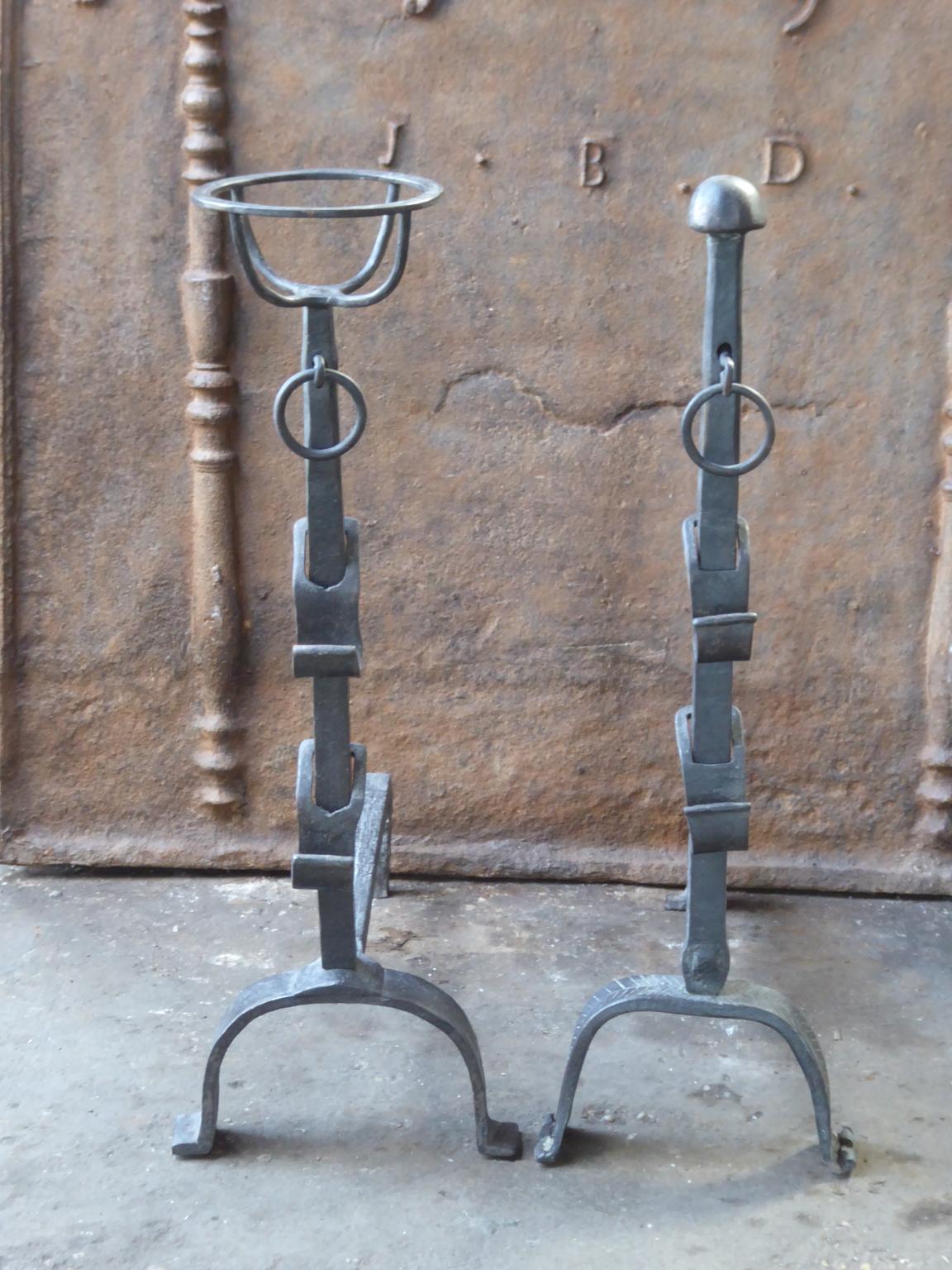 18th century French Louis XV andirons. The andirons are made of wrought iron. They have spit hooks to grill food. They are called 'pair de marriage' as the wife and husband each brought their own andiron to make a pair. The andirons are in a good