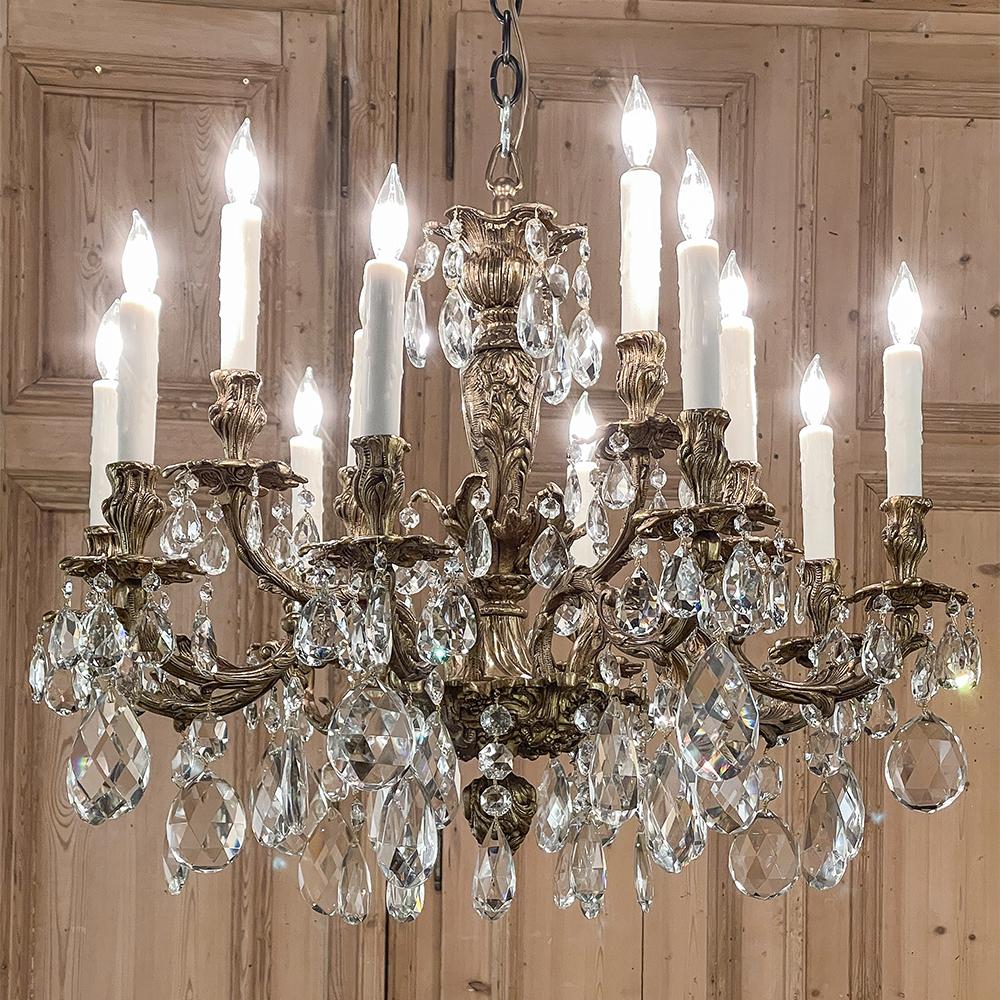 Antique French Louis XV bronze and crystal chandelier combines extraordinary elegance with style flair and the intriguing visual prismatic effect of cut crystals playing with the light to create the perfect centerpiece for any room! A total of