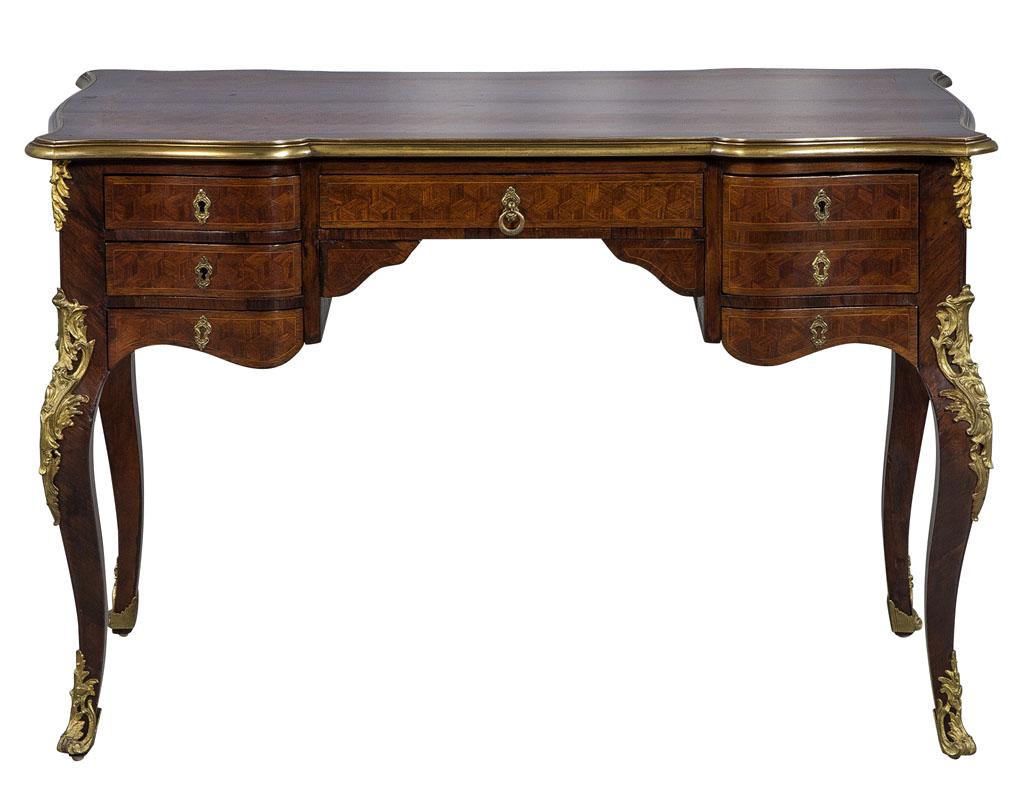 Antique French writing desk, with original bronze mounts. Finely detailed Kings wood inlay and parquetry top.