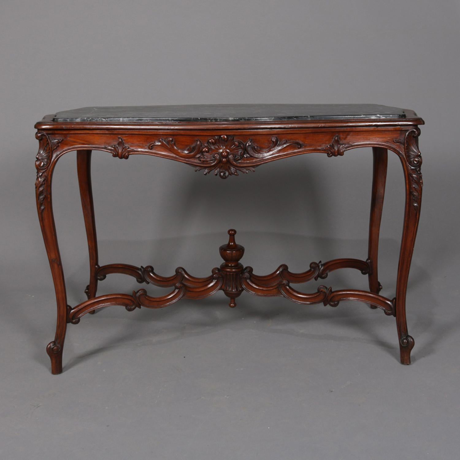 Antique French Louis XV centre table features mahogany base with shaped skirt having shell and foliate design supporting inset marble top and raised on cabriole legs with acanthus knees and c-scroll stretcher with central finial, circa