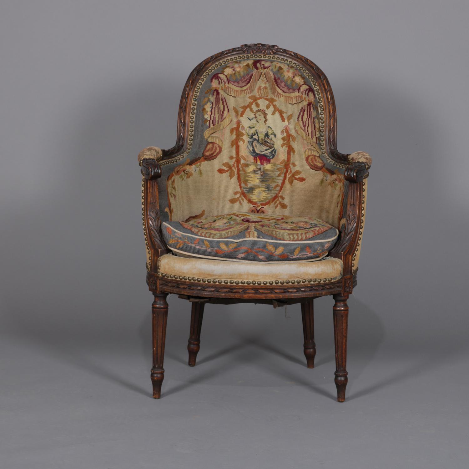 An antique French Louis XV style armchair features mahogany frame with carved relief ornament and scroll form arms, tapestry upholstered with central portrait with surrounding foliate motif, circa 1875.

Measures: 37