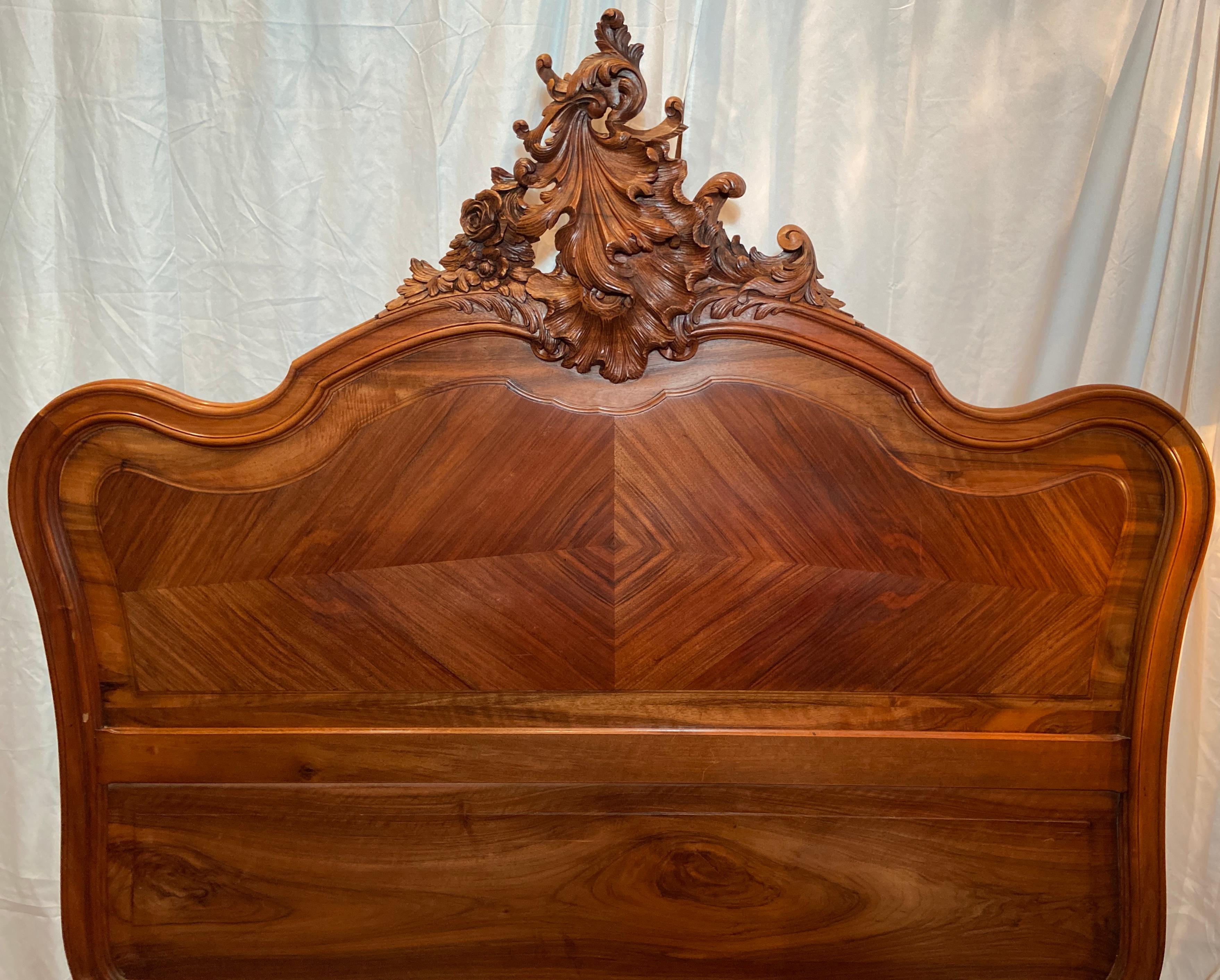 Antique French Louis XV finely carved walnut bed, circa 1880-1890.
Measurements: 
Headboard: 64 inches high x 57 inches wide 
Footboard: 39 inches high x 62 inches wide
Exterior Dimensions: 84 inches long x 60 inches wide 
Interior Dimensions: