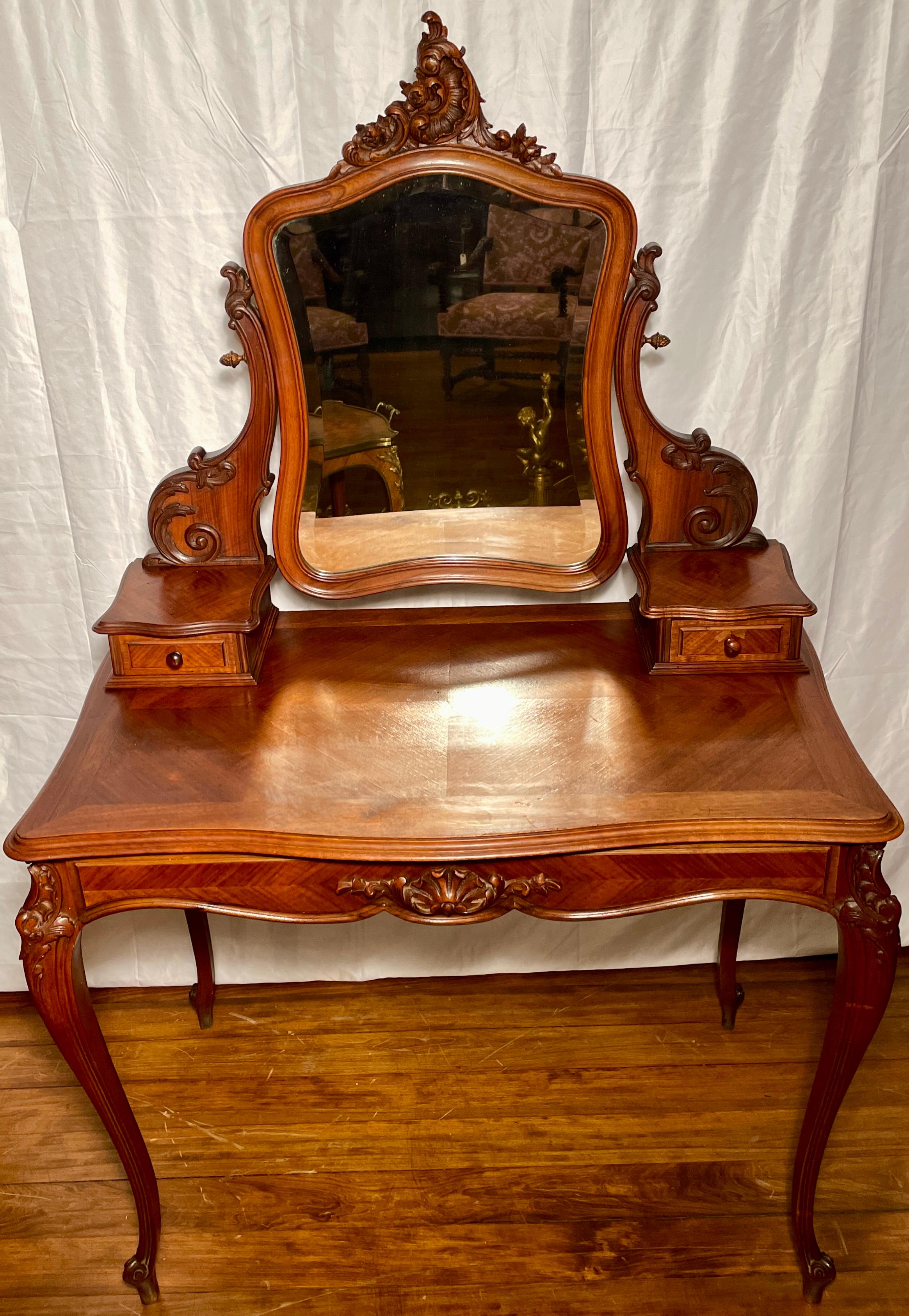 Antique French Louis XV carved walnut coiffeuse or vanity dressing table with beveled mirror, circa 1890.