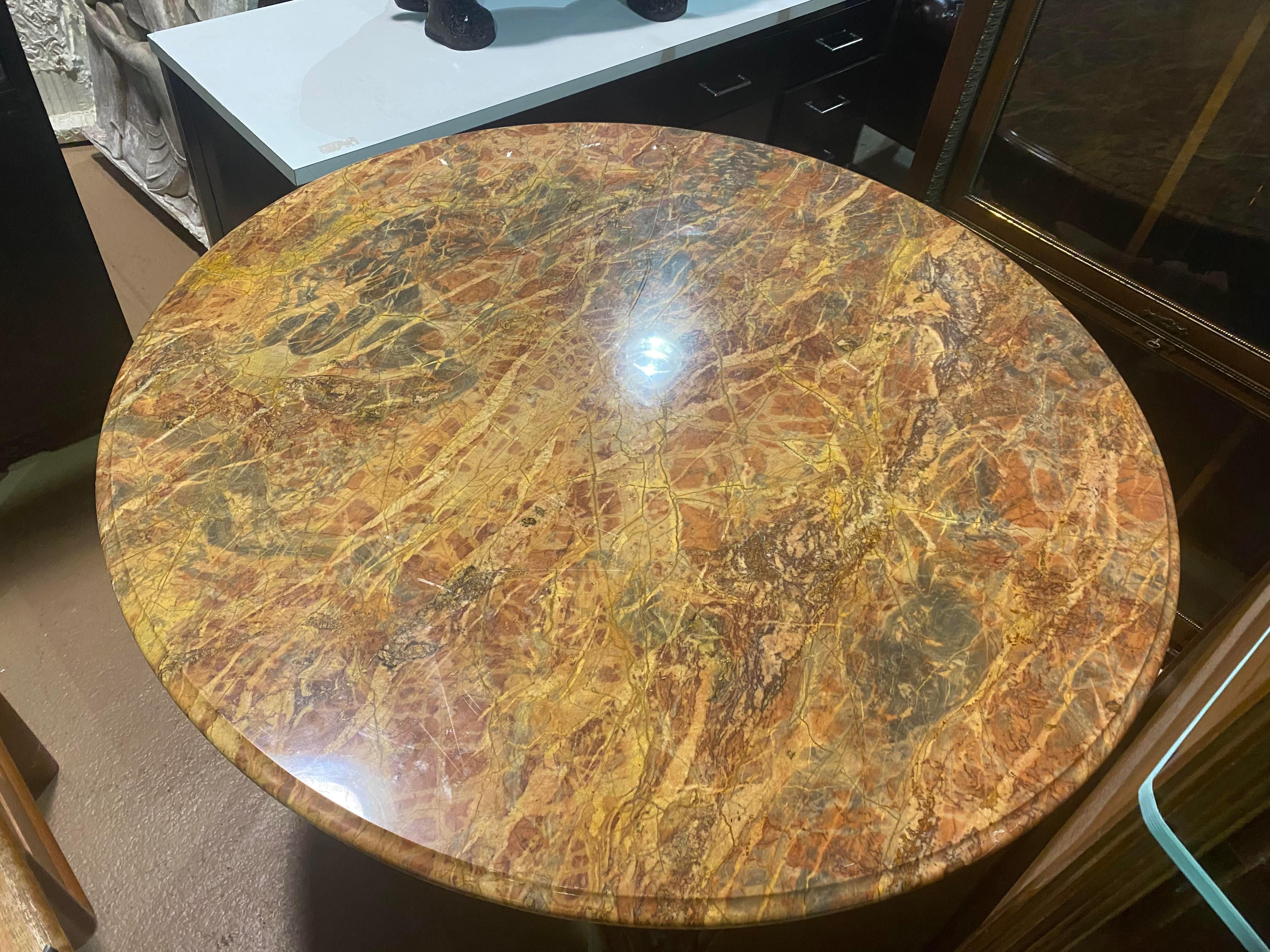 This is a gorgeous and unique table. Possibly usable as a breakfast or dining table with tall enough dining chairs, this table features a superb Breche marble top and intricate carvings. The base does have some minor age cracks which do not make the