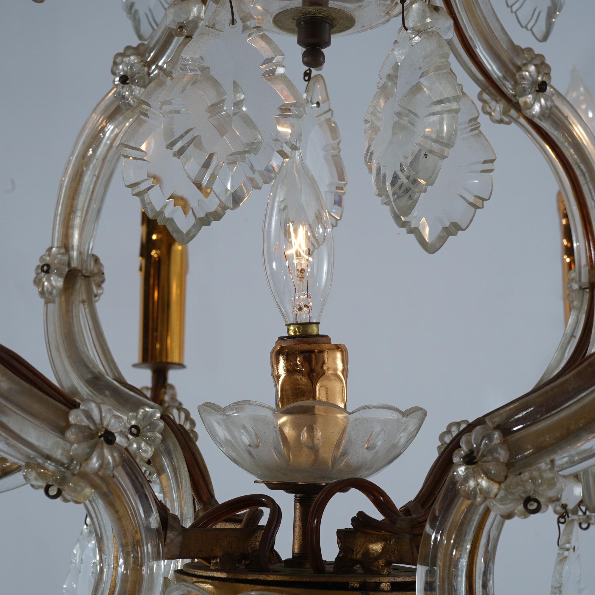 ***Ask About Reduced In-House Shipping Rates - Reliable Service & Fully Insured***
An antique French Louis XV style chandelier offers scroll form frame with eight arms terminating in candle lights, cut crystal prisms throughout, c1920

Measures-