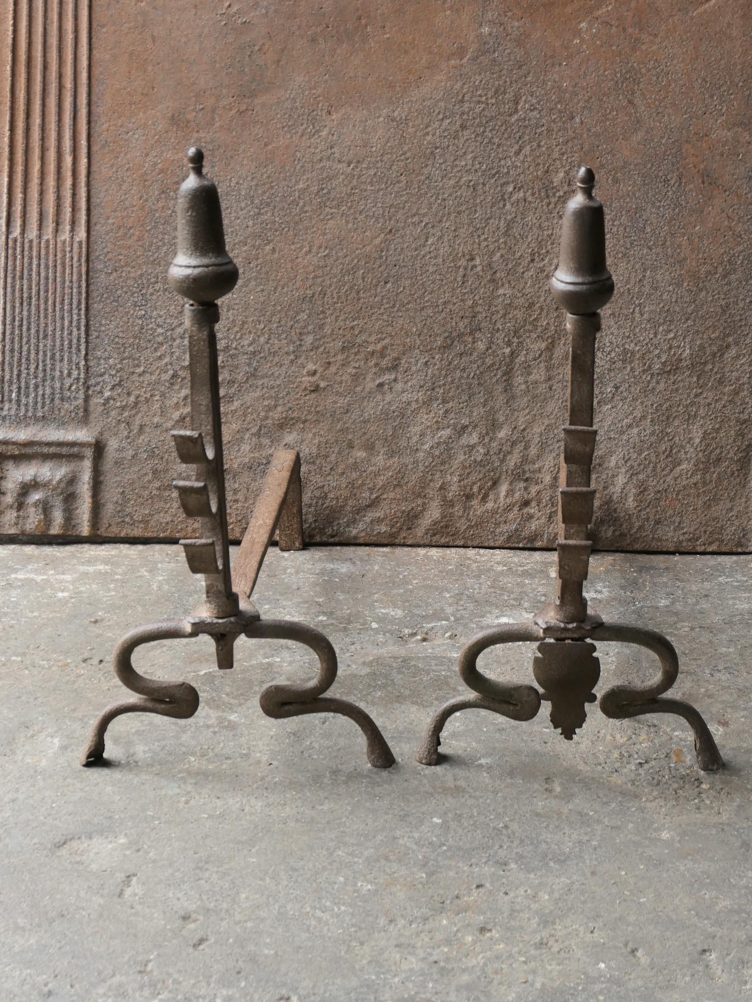 18th Century French Louis XV period andirons. Made of wrought iron. The andirons have spit hooks on which a spit can be put for cooking. The andirons are in a good condition and are fully functional. The left andiron misses a decoration as can be