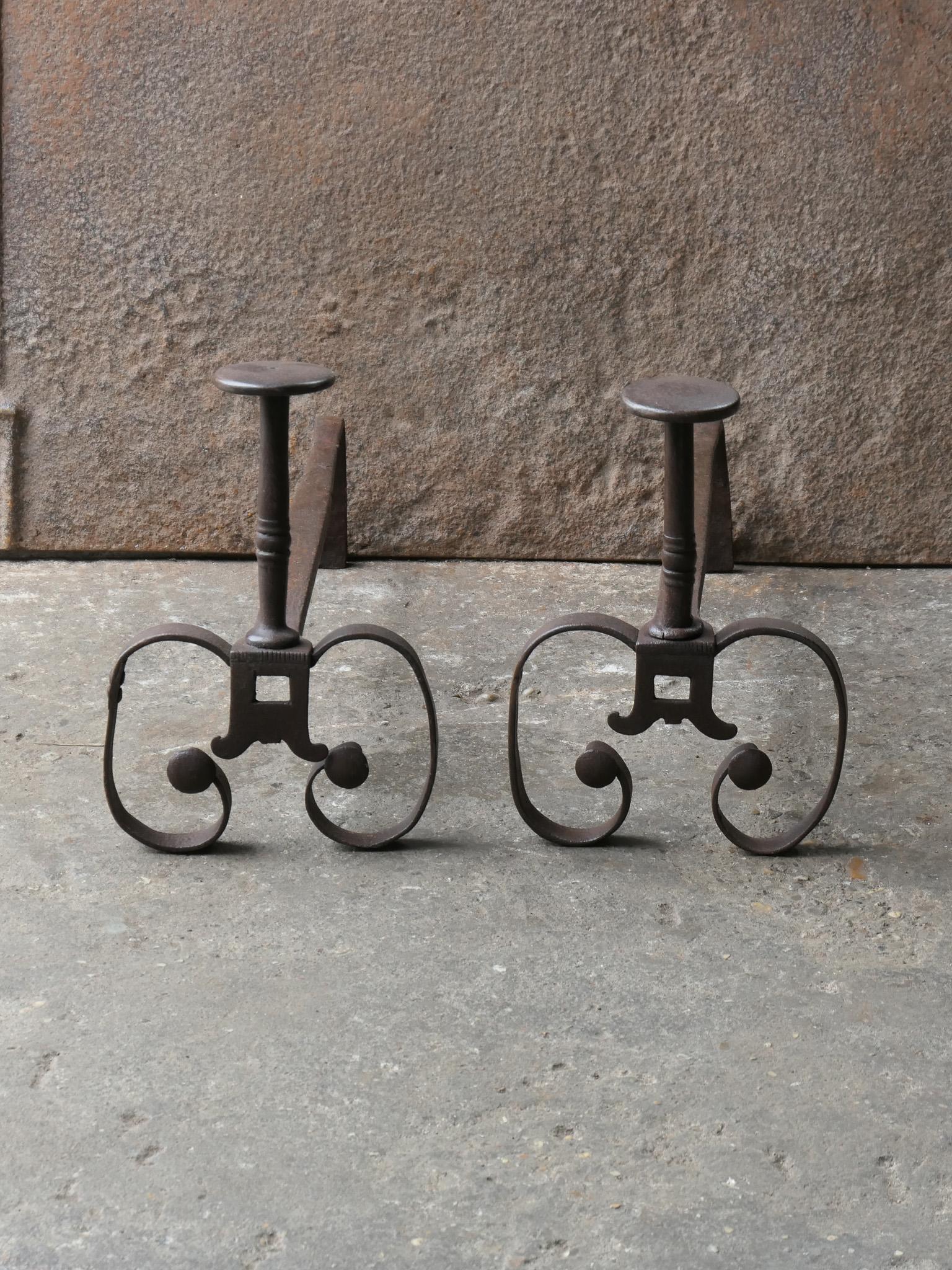 18th Century French Louis XV period andirons. Made of wrought iron. The andirons have spit hooks on which a spit can be put for cooking. The andirons are in a good condition and are fully functional. 