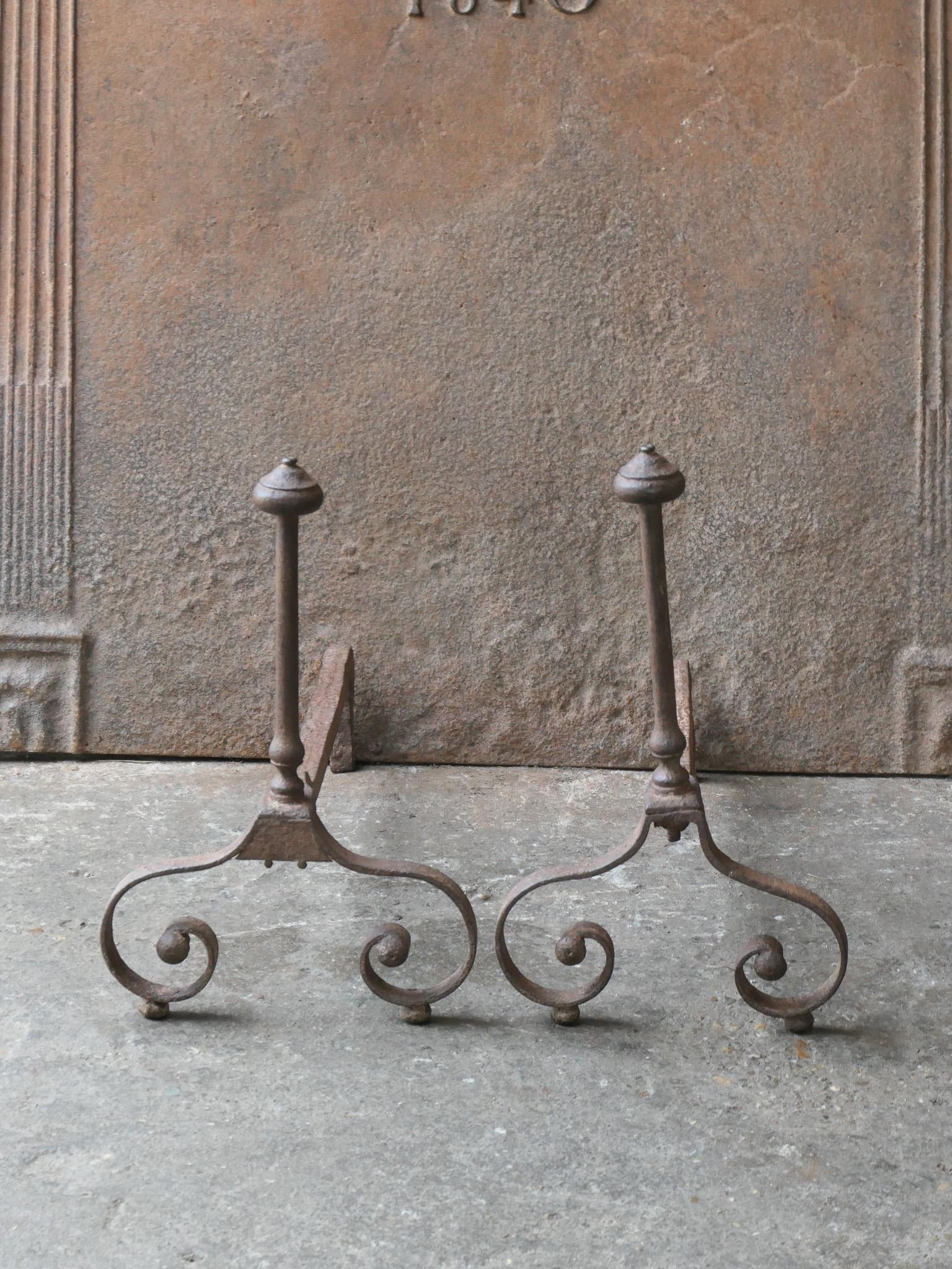 18th Century French Louis XV period andirons. Made of wrought iron.  The andirons are in a good condition and are fully functional. 