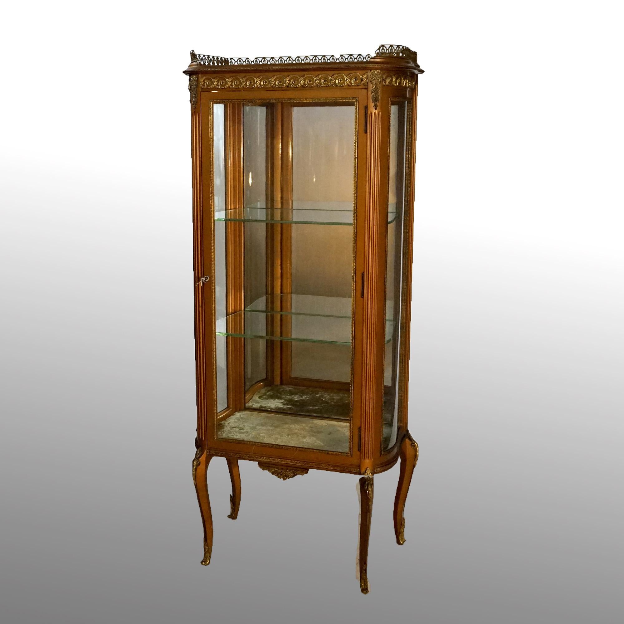 An antique French Louis XV display vitrine offers giltwood construction with upper pierced gallery over case with single drawer opening to mirrored and shelved interior with velvet lined floor, raised on cabriole legs, foliate cast ormolu mounts
