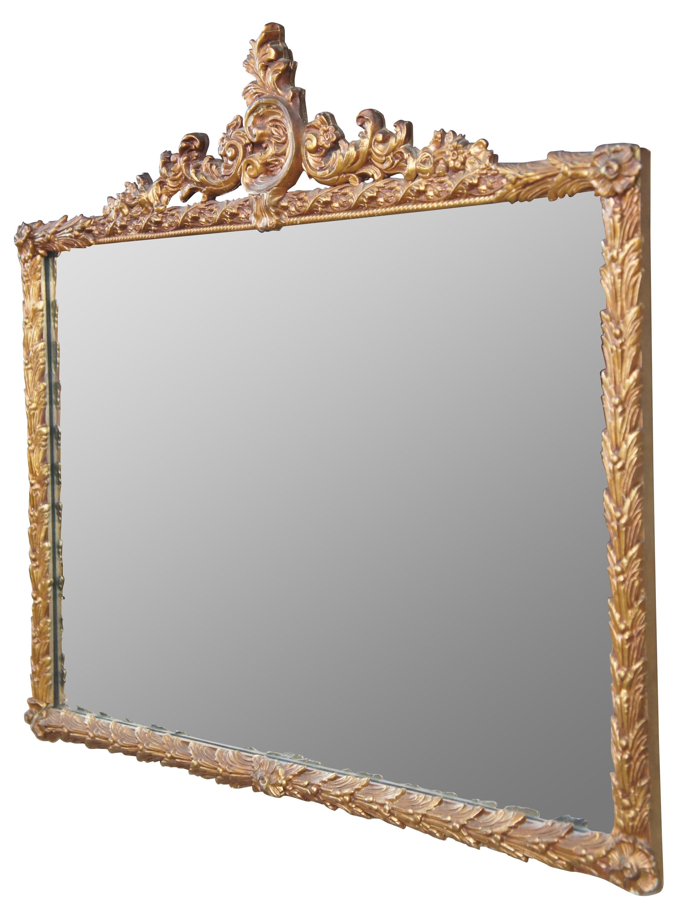 Antique French Louis XV Rococo mirror. Features ornate gold gilt frame with florals and scalloping. Measure: 35