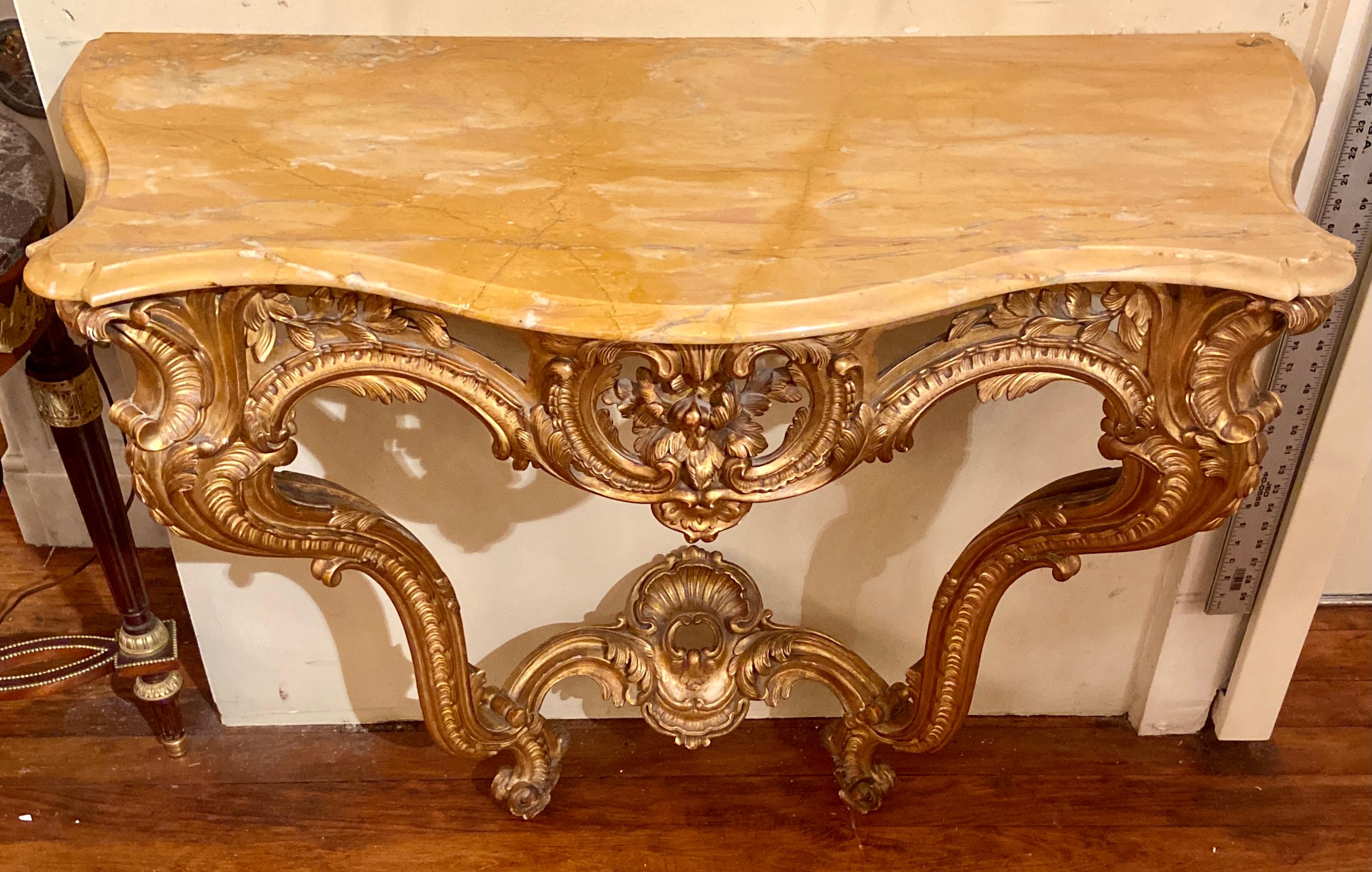 Antique French Louis XV Style carved wood with gold leaf and marble-top console table, Circa 1860.
A console never fails to please! This is a very nicely carved piece, a definite eye-pleaser and sure to command attention in its new home location.