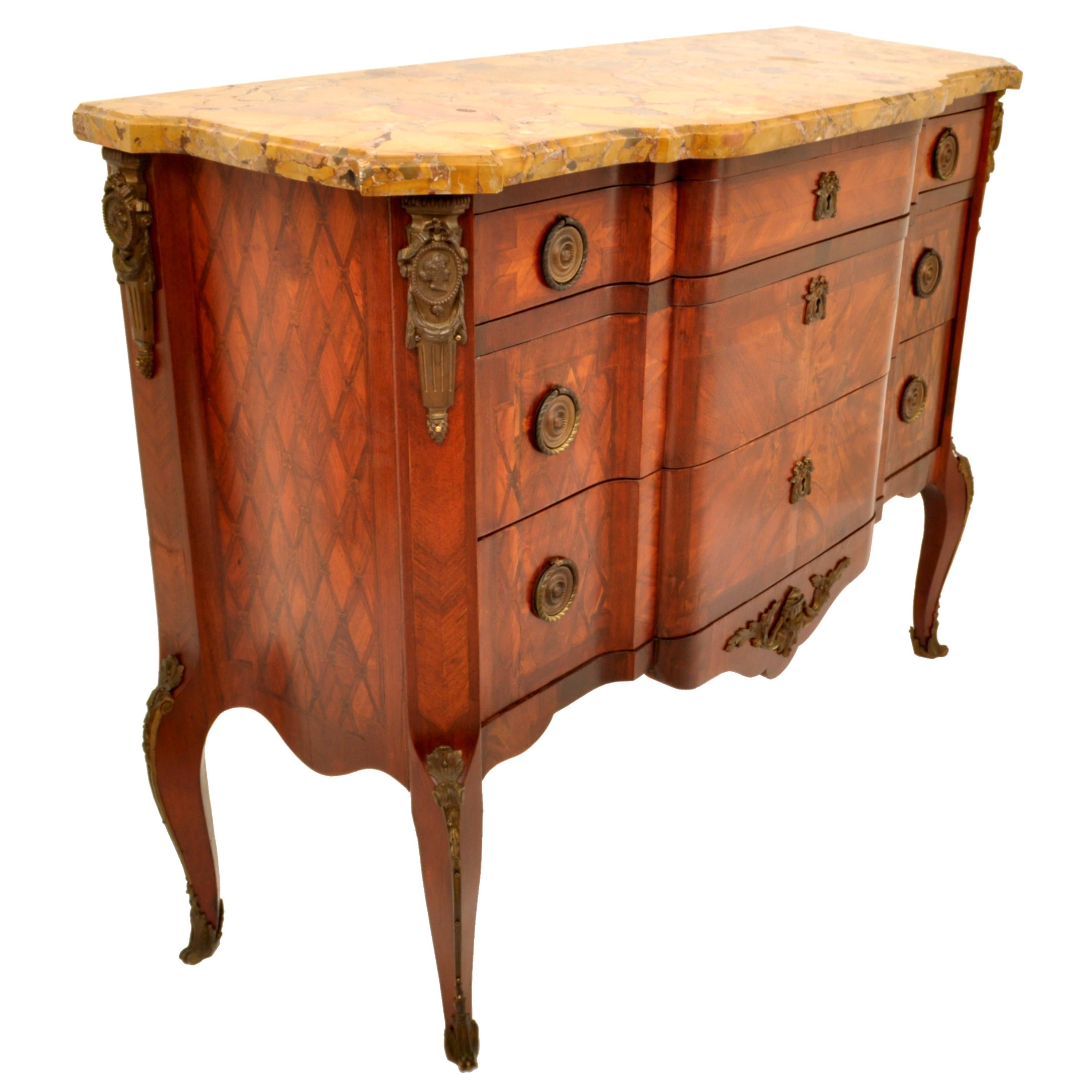 A very fine period antique French Louis XV/XVI inlaid walnut & marble top & ormolu mounted commode/chest, circa 1780.
The commode having the original Breccia specimen marble top, the commode of breakfront form and having three graduated drawers,