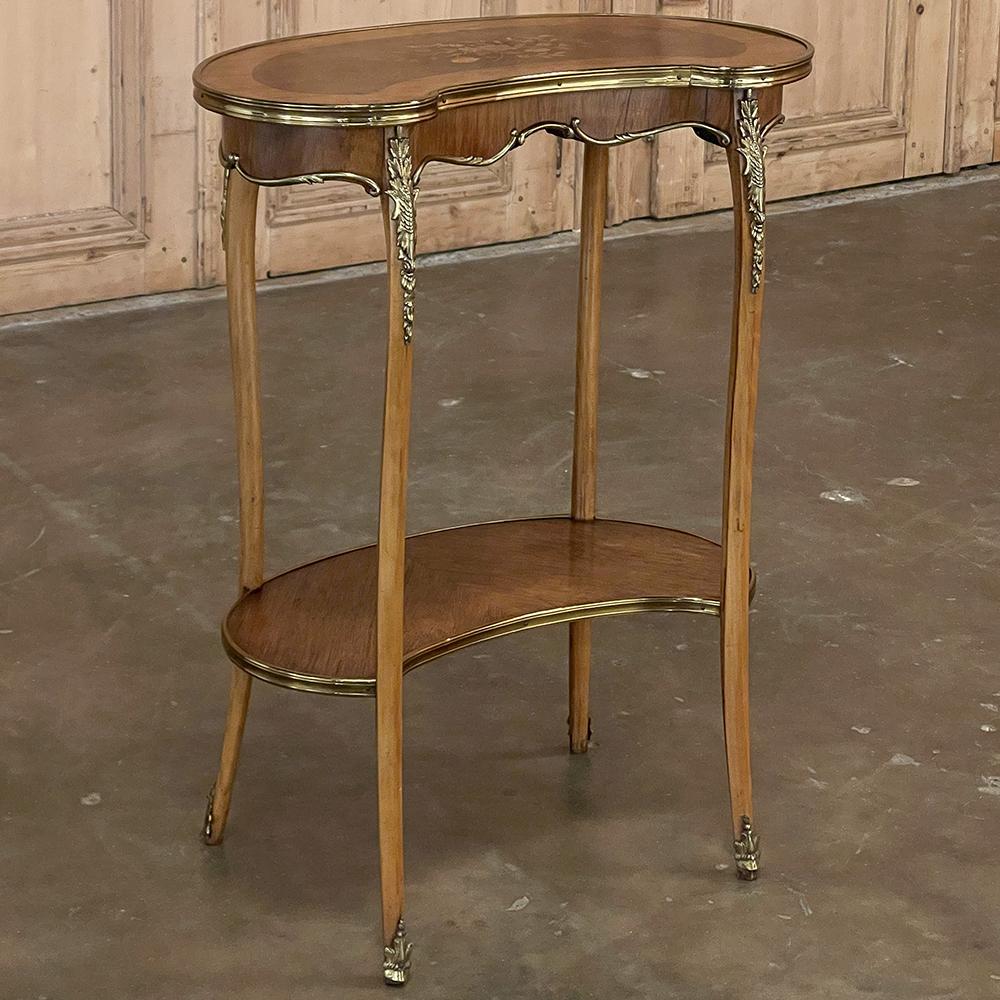 Antique French Louis XV kidney shaped marquetry end table combines convenient size with double the surface area plus incredible artistry. Utilizing various shades of walnut and satinwood, the two surfaces feature oriented grain for added visual