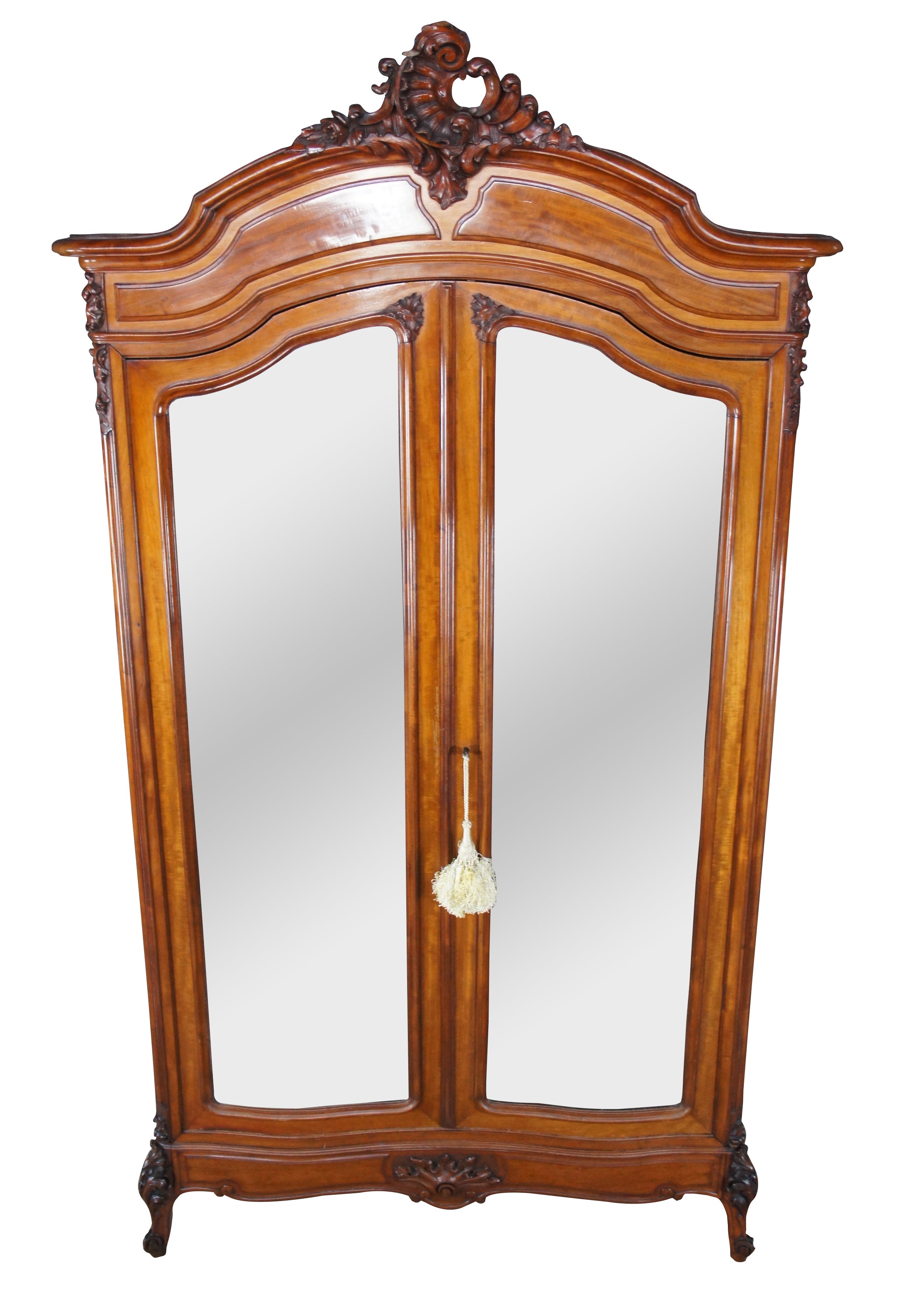 Monumental 19th century Louis XV / Rococo wardrobe or linen Press. Made of mahogany with a beautiful wood grain. Features serpentine aprons with magnificent foliate, acanthus and baroque inspired carvings. Includes large beveled mirrored doors and