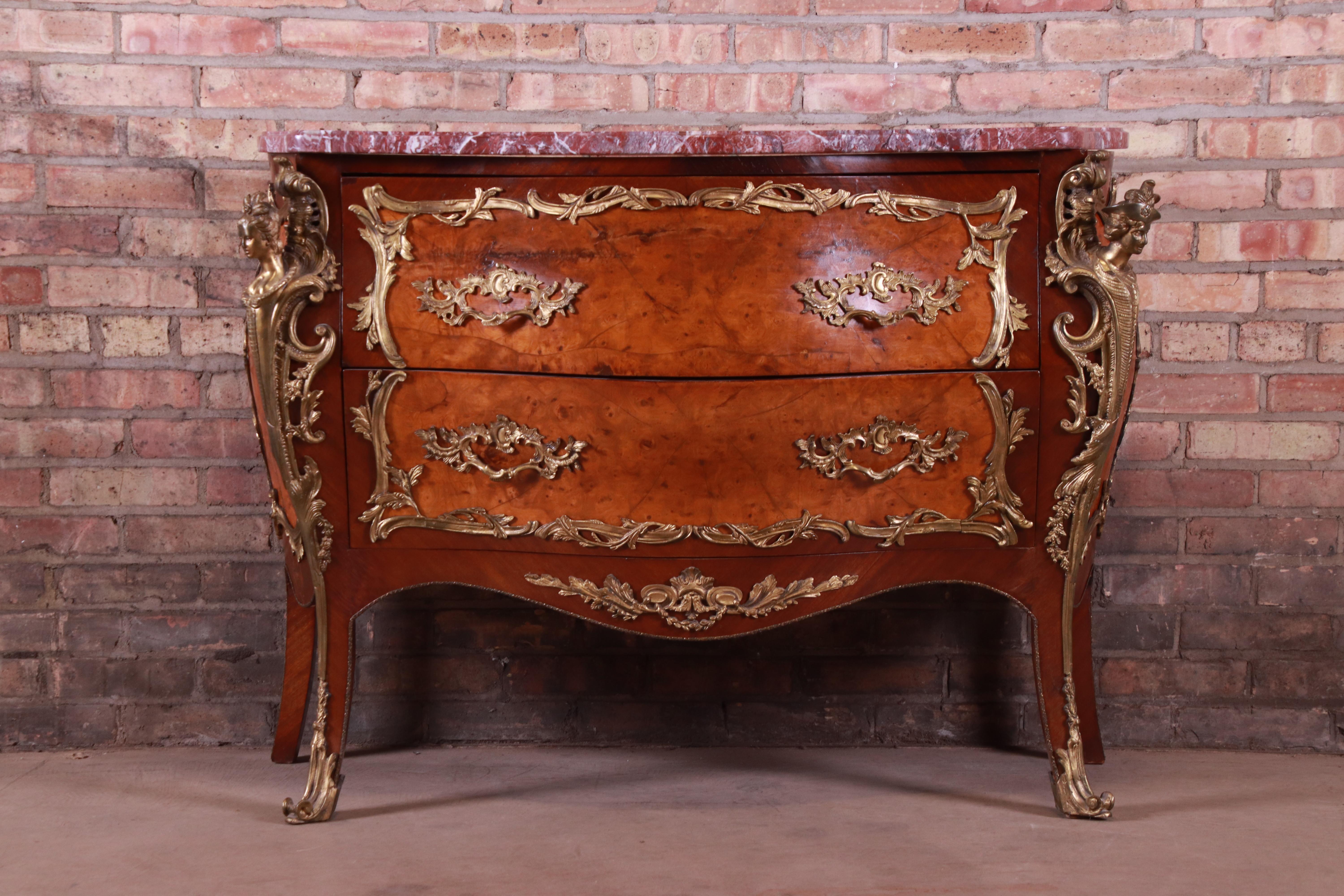 An exceptional antique French Bombay commode or chest of drawers

France, early 20th century

Mahogany, with inlaid burled walnut, mounted bronze ormolu, and beveled marble top.

Measures: 46.25