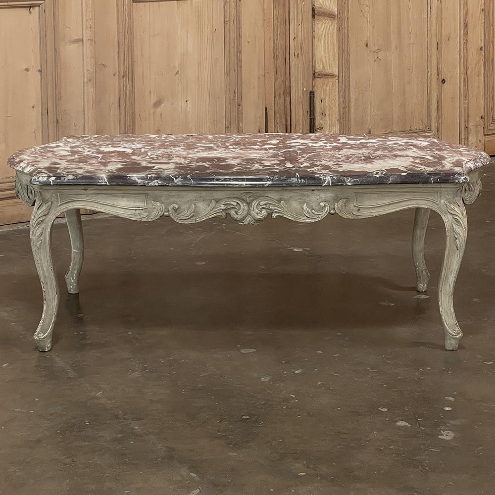 Antique French Louis XV marble top painted coffee table is a great example of understated elegance! The graceful contours of the style have been presented on all four sides with a richly contoured apron all around carved with exquisitely wrought