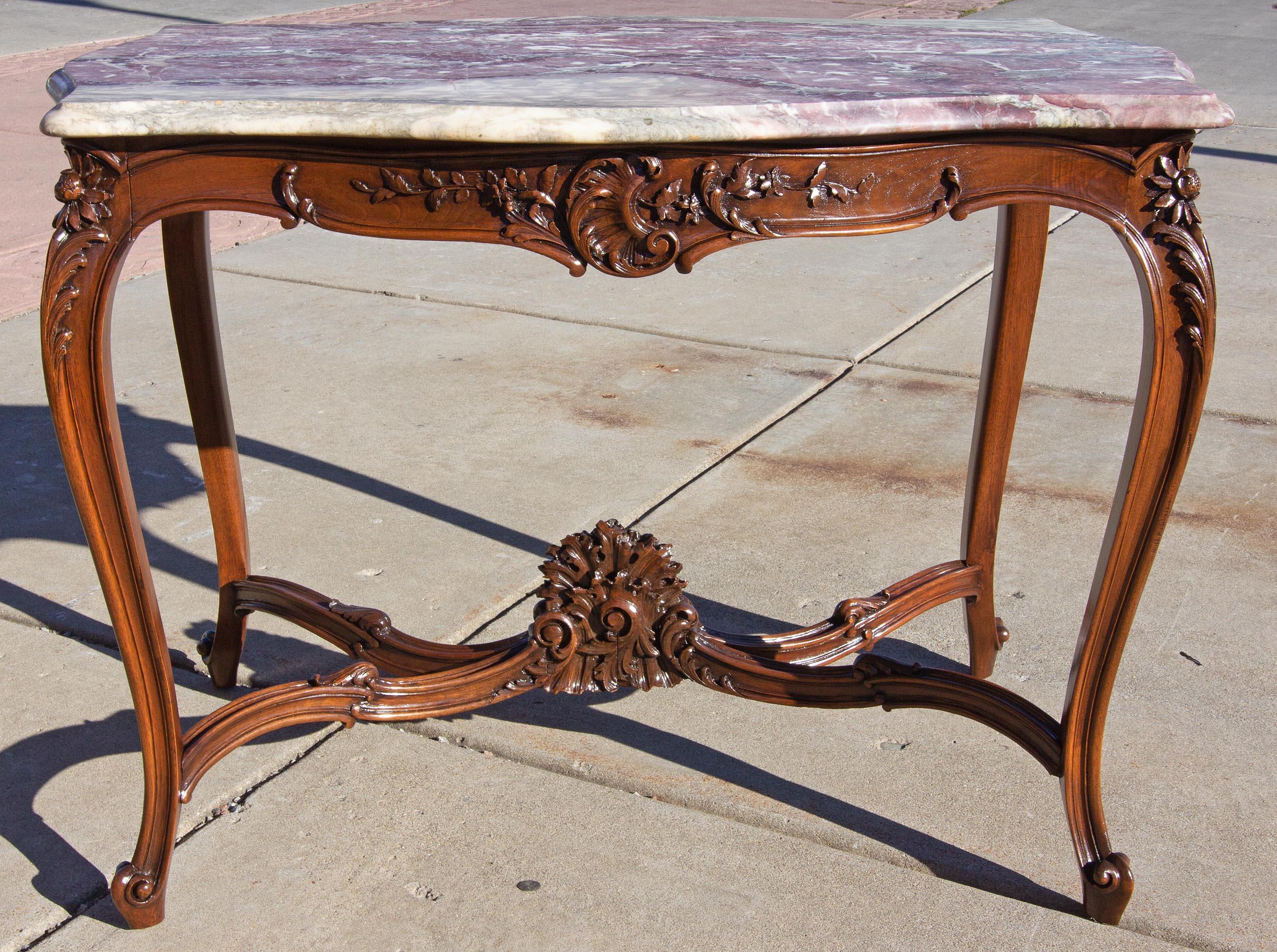 19th century French marble top side table. Beautiful mauve and gray graphic marble top. Hand carved walnut base.
  