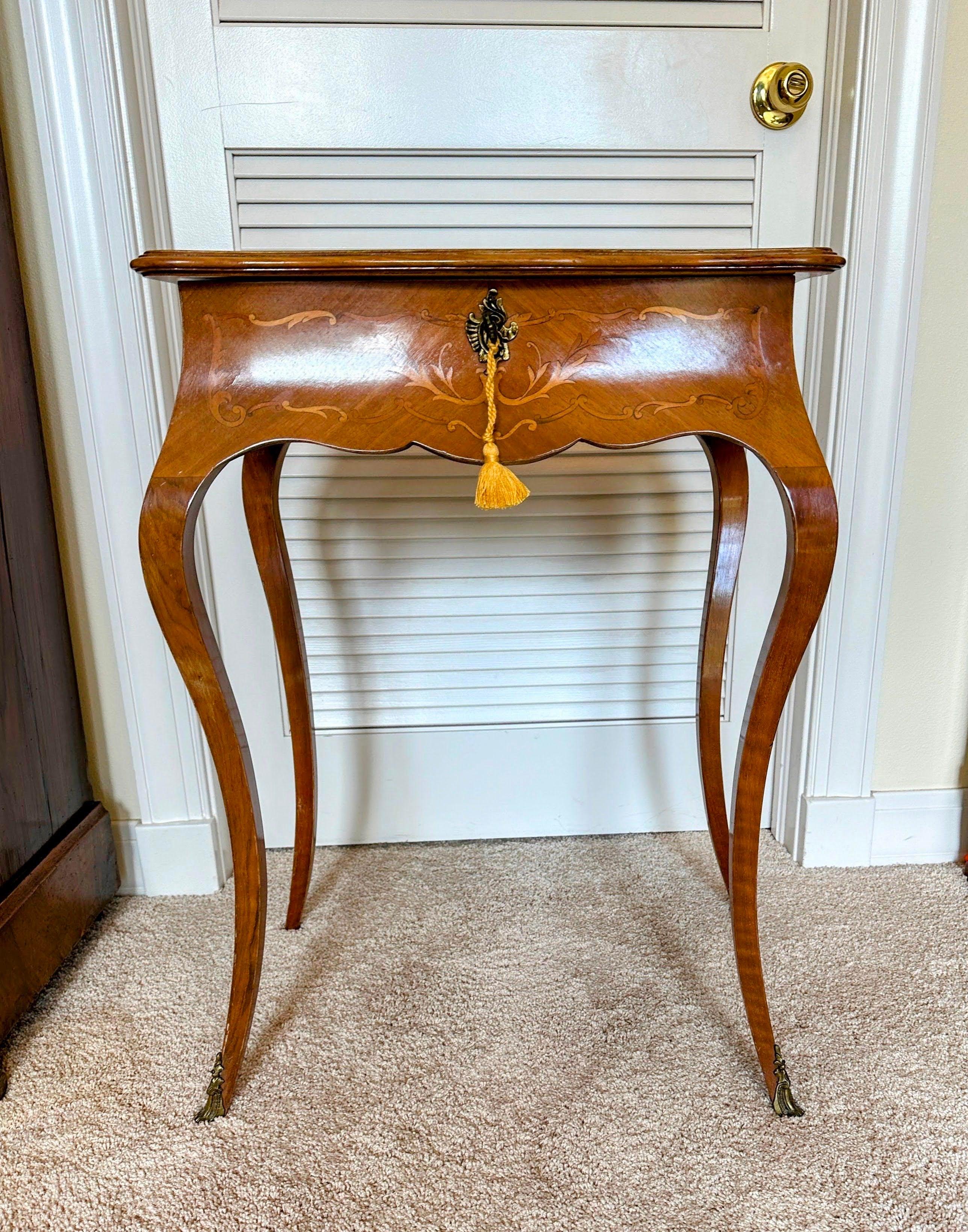 Antique French Louis XV - Napoleon III Travailleuse Sewing Work Vanity Table. This table features marquetry in lemon wood. The ornate top flips up to display a rectangular mirror with compartmental storage. The table sits on cabriole legs, bronze