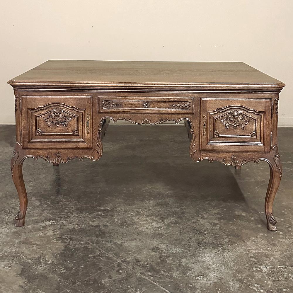 Antique French Louis XV Oak Partner's Desk is perfect for two working simultaneously, or for one with two businesses!  One side is four drawers, while the other is a drawer and two cabinets with shelves inside.  The solid oak construction ensures