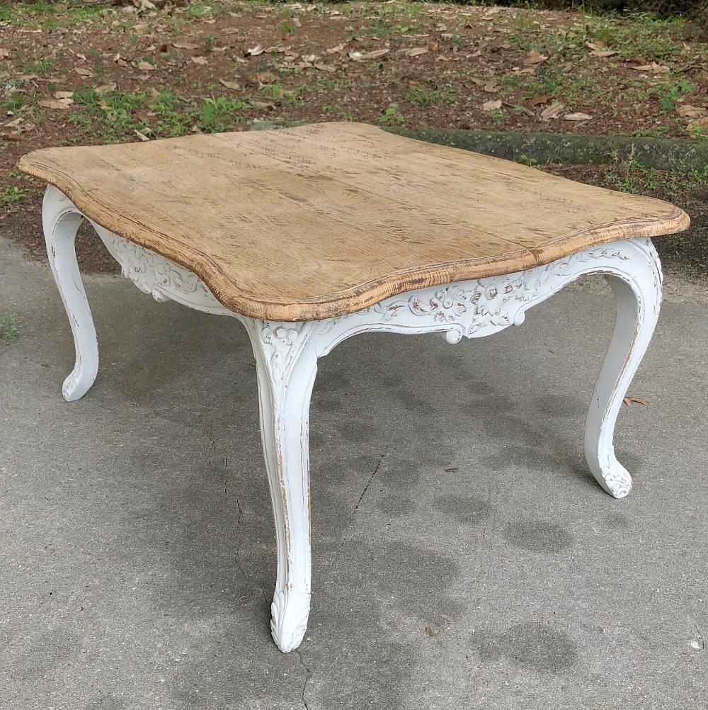 Antique French Louis XV painted coffee table features a lot of Rococo flair in a diminutive piece, with natural finish on the top contrasting with the slightly distressed painted apron and legs, all carved with fine artistry for your visual