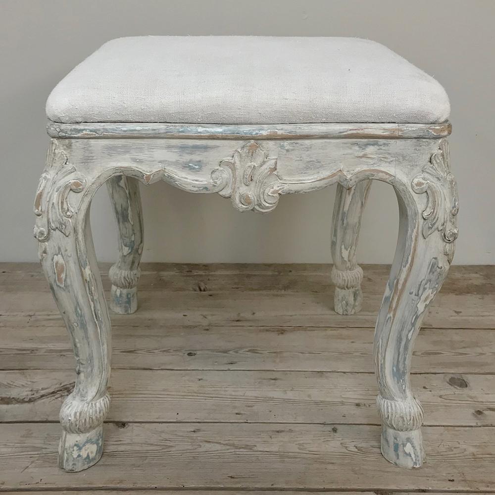 Antique French Louis XV painted Vanity stool features boldly scrolled legs and apron carved with shell and foliate motifs, enhanced by the patinaed painted finish. New neutral upholstery only adds to the allure!
circa early to mid-1900s.
Measures: