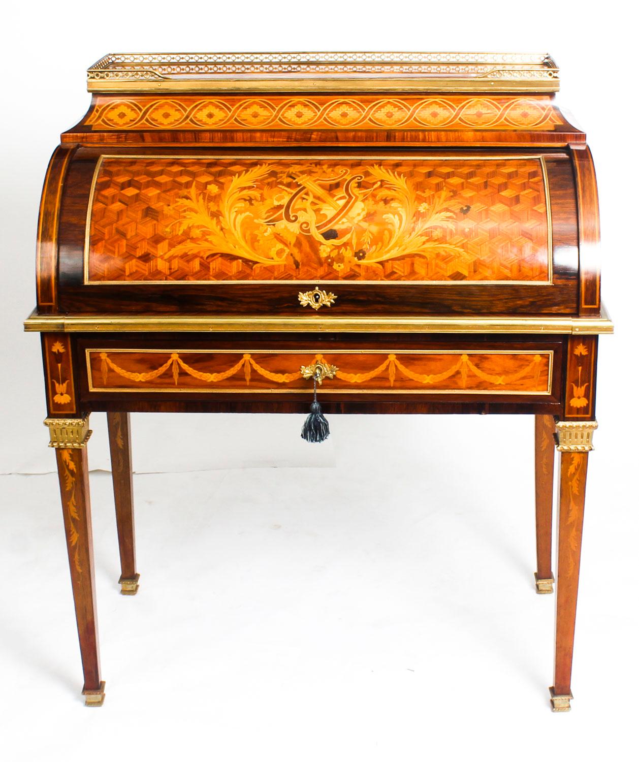 This is a gorgeous antique French Louis XVI style kingwood bureau a cylindre, in the manner of Riesener, bearing the ivorine label of the renowned retailer and cabinet maker Howard & Sons, circa 1880 in date.

It has a pierced brass galleried top