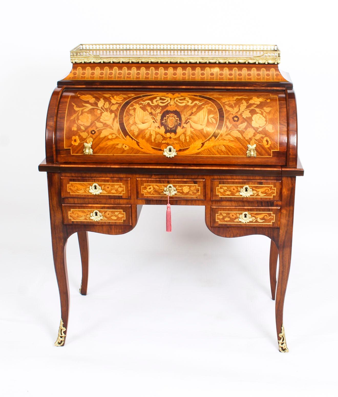 This is a gorgeous antique French kingwood and walnut marquetry Louis XV Revival secretaire a cylindre, circa 1870 in date.

It is decorated throughout with beautiful floral marquetry and the centre of the cylinder has a stunning oval heraldic