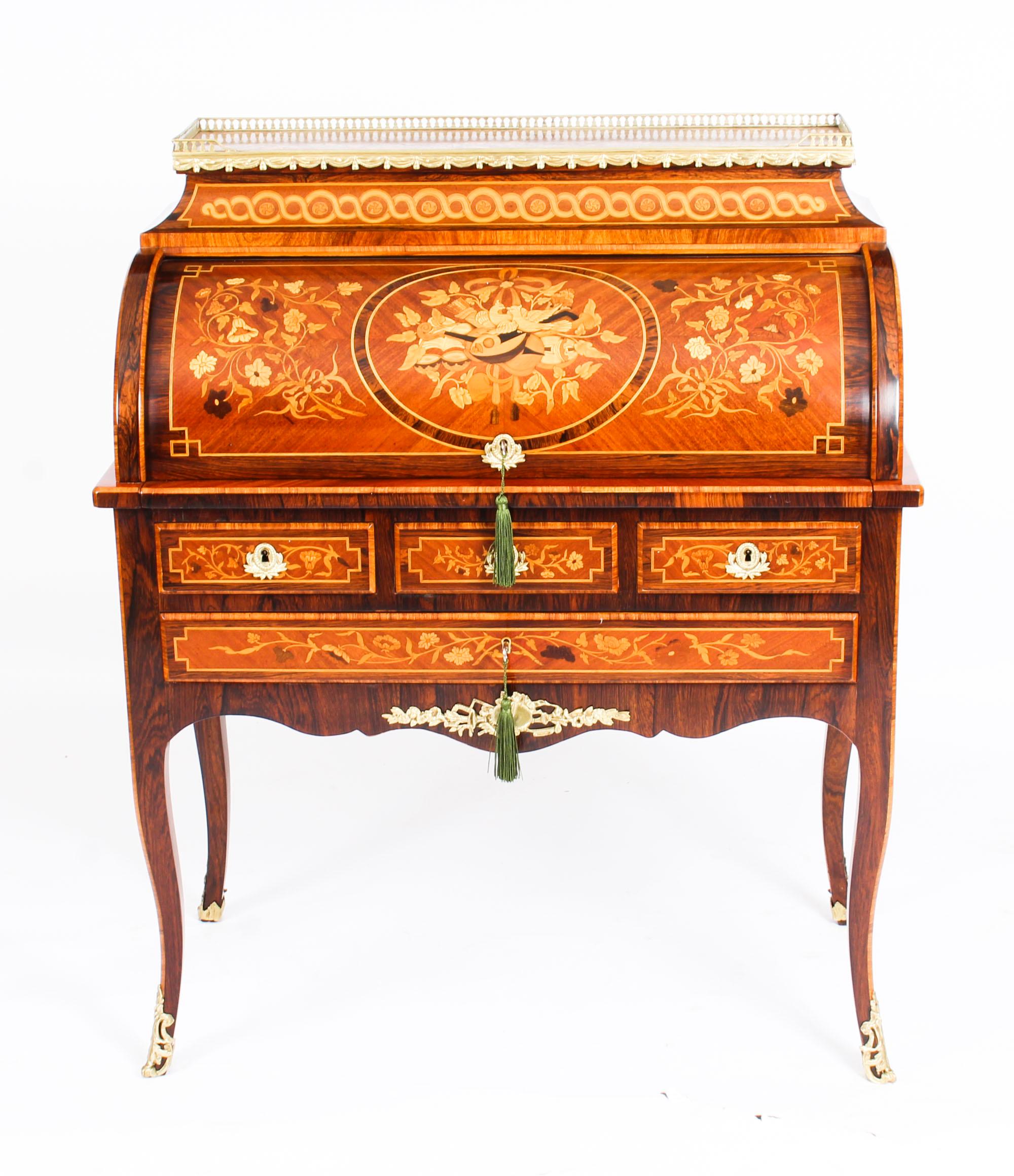 This is a magnificent antique French kingwood and walnut marquetry Louis Revival secretaire a cylindre, circa 1870 in date.

It is decorated throughout with beautiful floral marquetry with trophies, lovebirds and flowering stems, the centre of the
