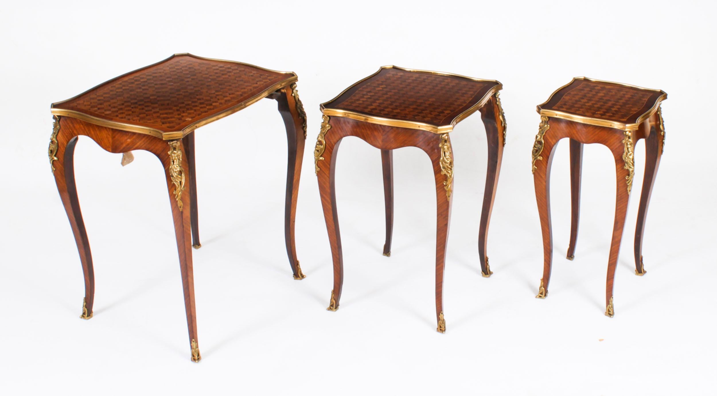 This is a fine antique French Louis Revival Walnut and Ormolu mounted parquetry nest of  tables, circa 1900 in date.

The nest consists of a set of three interlocking tables each with  parquetry  decoration,  shaped rectangular tops with ormolu