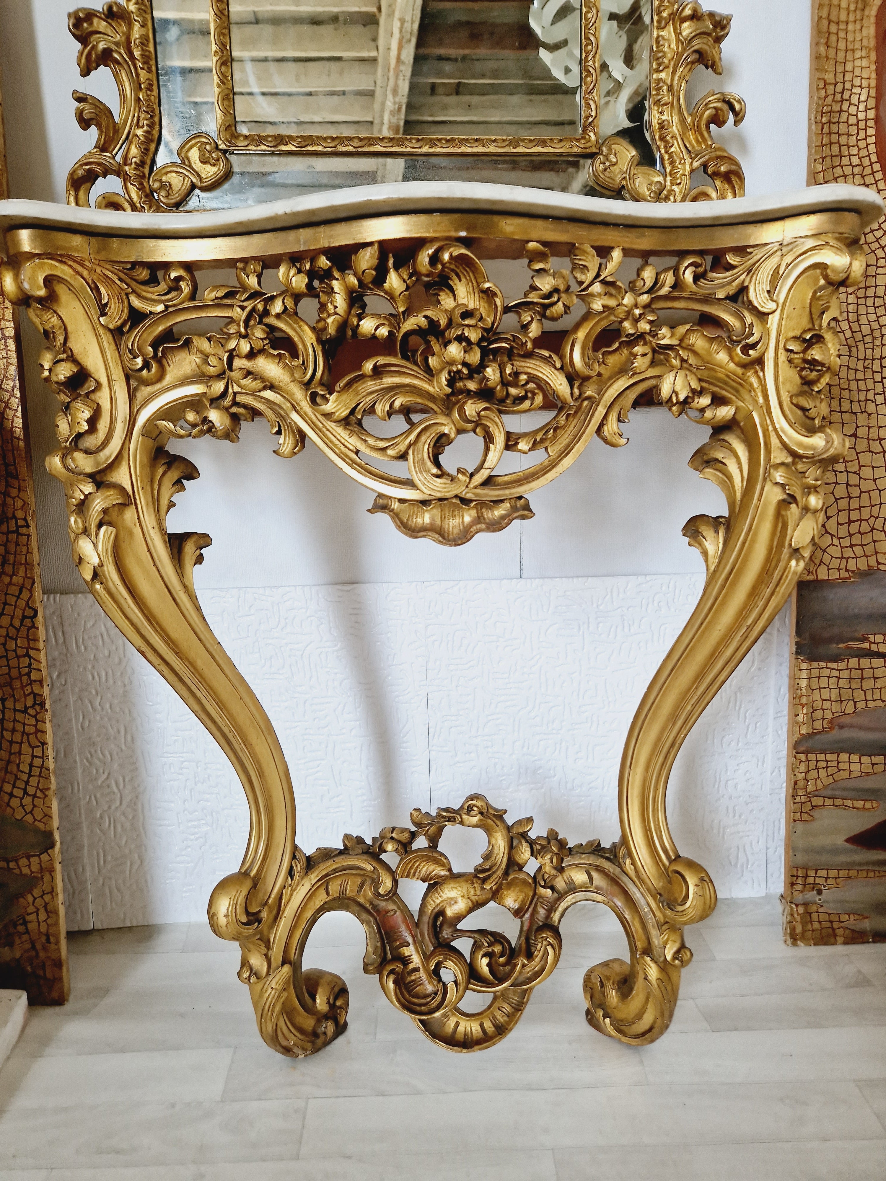 This antique French console table features a beautiful Rococo design from the Louis XV period. Its rectangular shape and fully assembled status make it an ideal addition to any indoor room. The tabletop and material is marble, the console table base