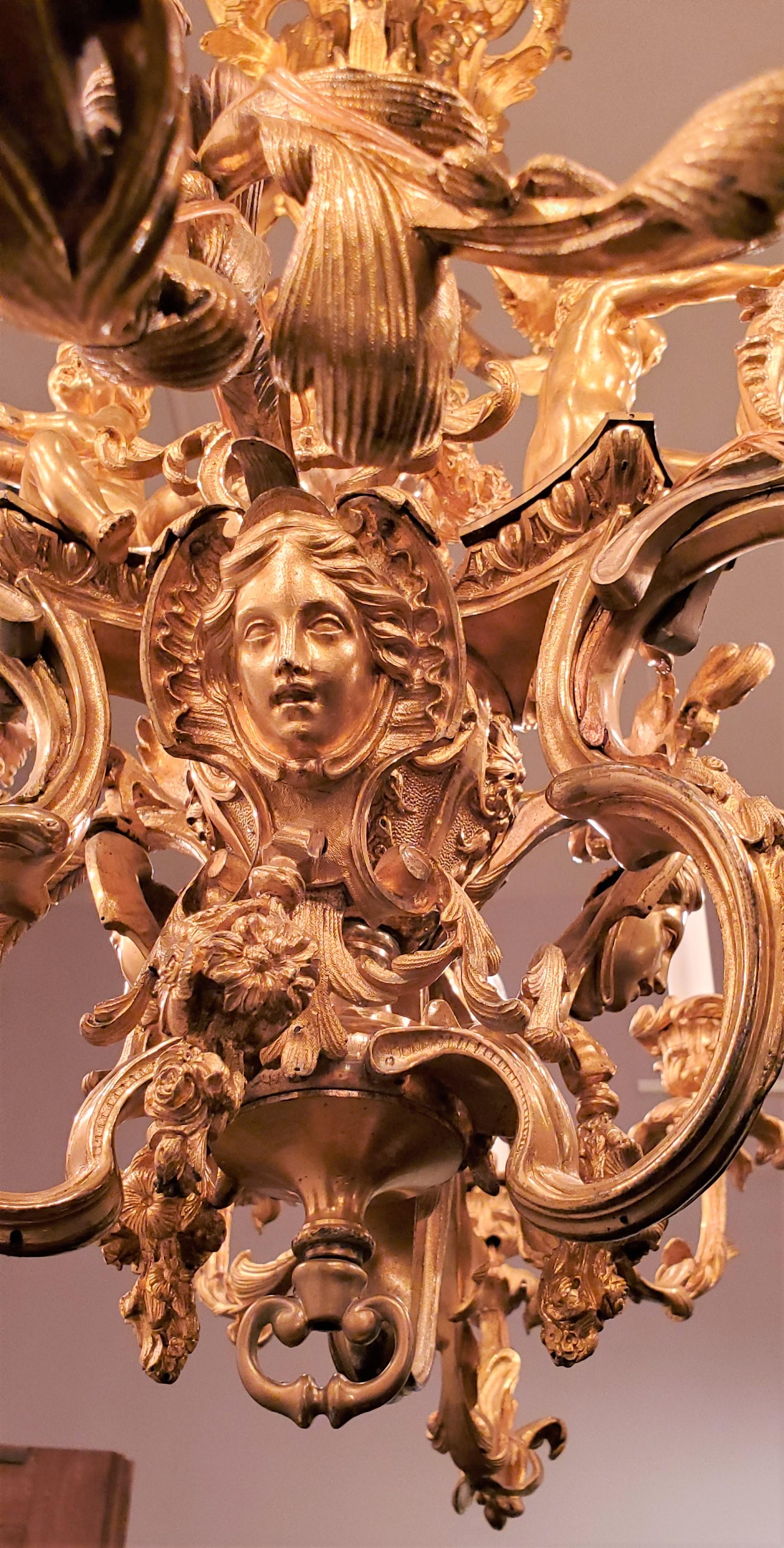 Antique French Louis XV broneze chandelier with cherubs and other fine elements.