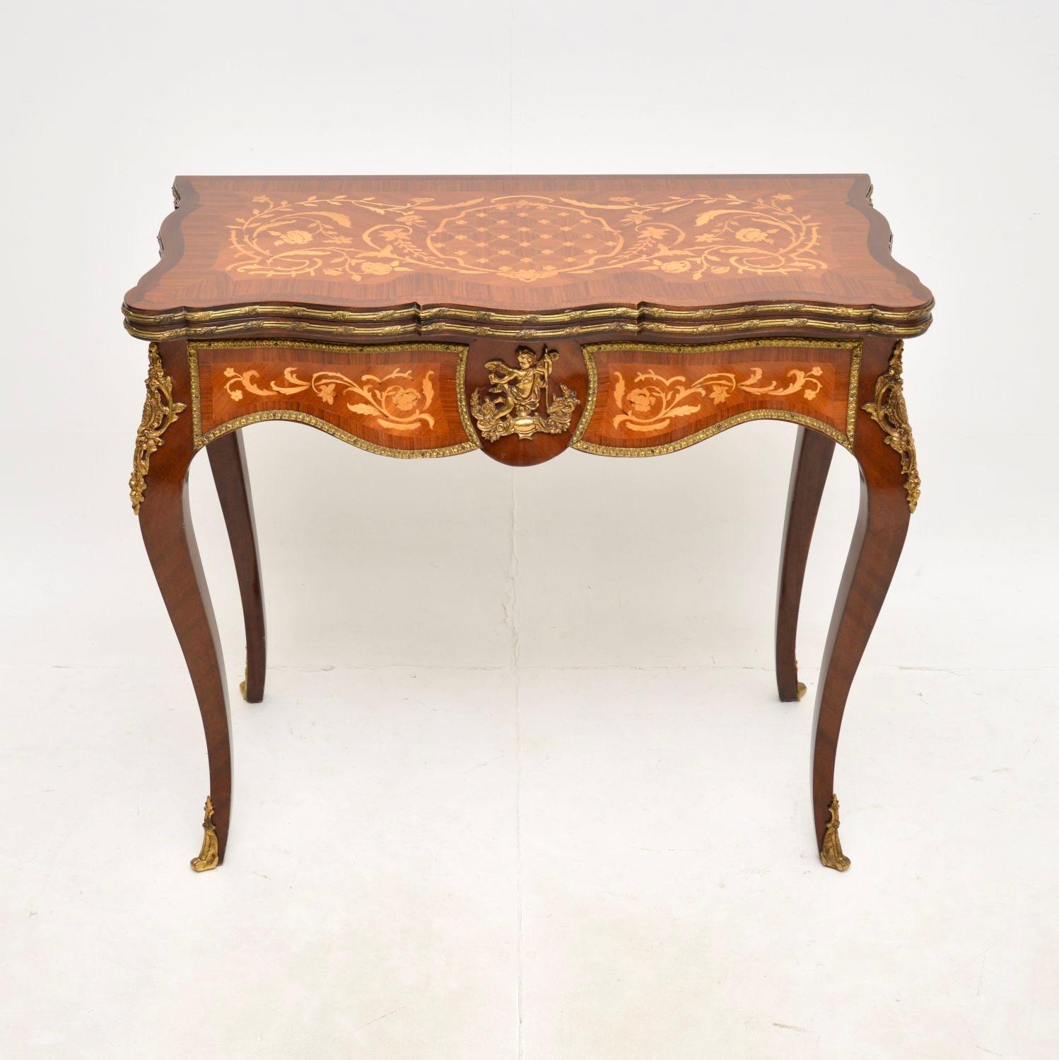 An absolutely stunning antique French card / console table, dating from the 1920-30’s.

The quality is outstanding, this has a gorgeous design with lots of nice features. The wood is predominantly walnut, with profuse inlays of satinwood and various