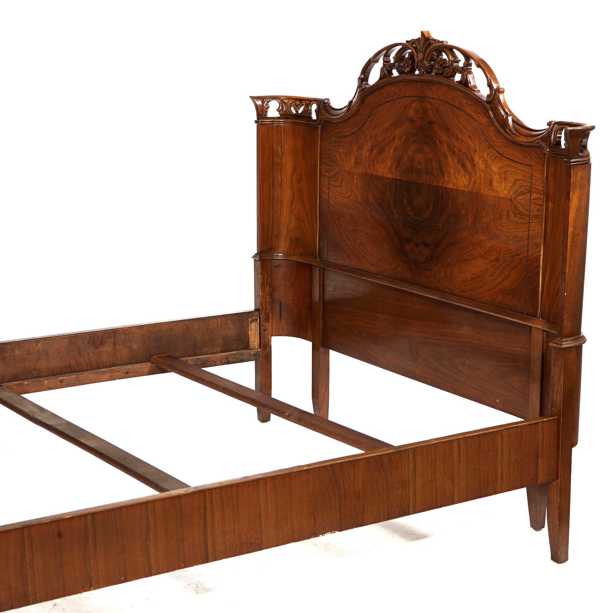 An antique French double bed in the manner of Louis XV offers flame mahogany construction with curved headboard and footboard having pierced foliate carved crests and raised on acanthus carved legs, c1930

Measures- exterior 50''H x 58.5''W x