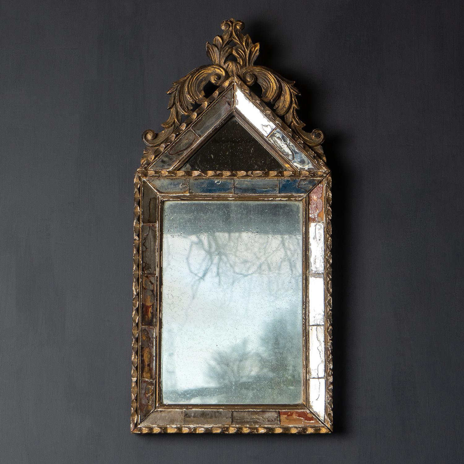 Antique Baroque style cushion mirror

A very decorative and elegant mirror with carved foliate details over the pediment top section.

There is wear throughout which we think adds to its charm, and aesthetic and tells its story. The wooden
