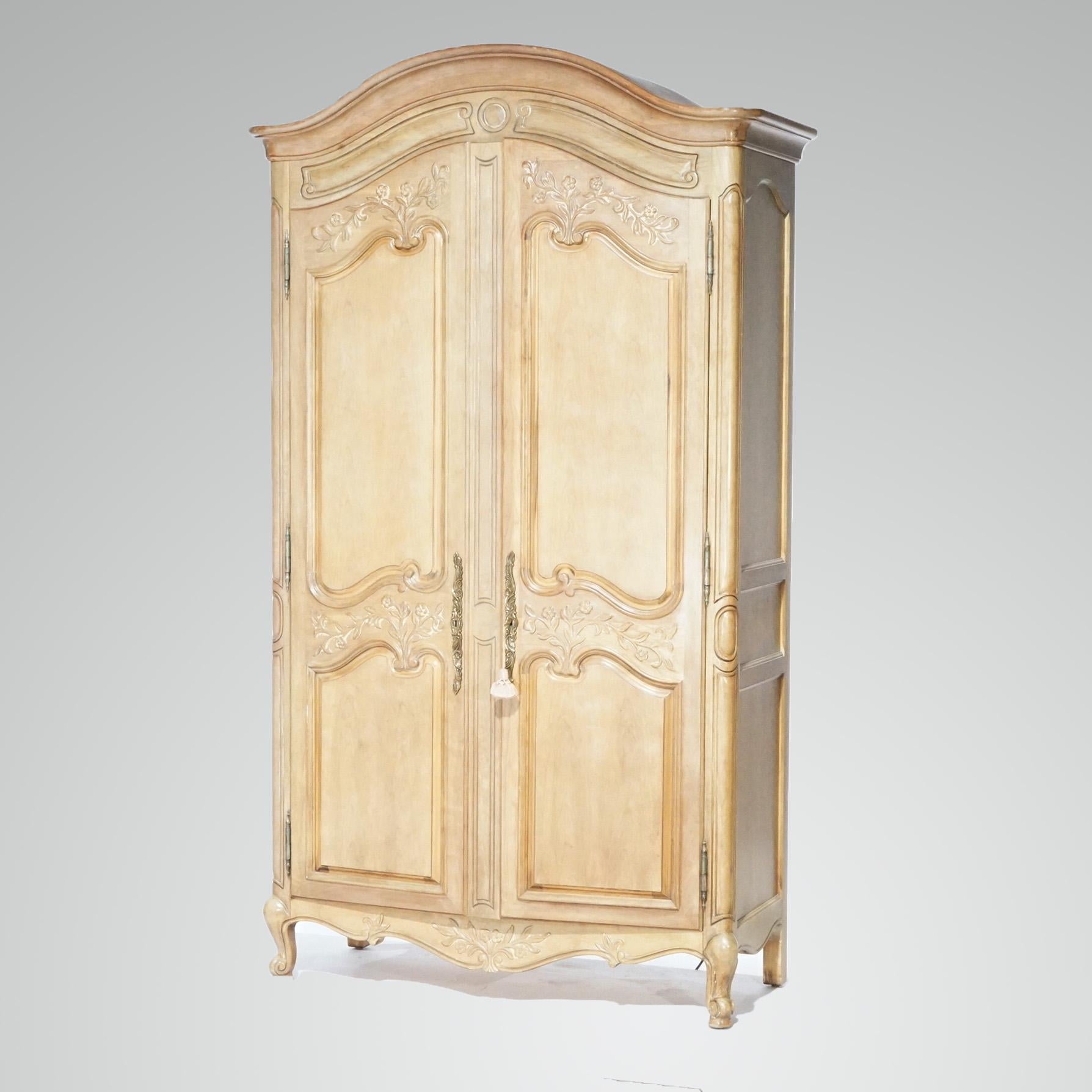 A French Louis XV style armoire by White Furniture offers satinwood construction with arched top over raised panel case having double doors opening to storage interior, raised on cabriole legs, maker mark as photographed, 20th century

Measures -