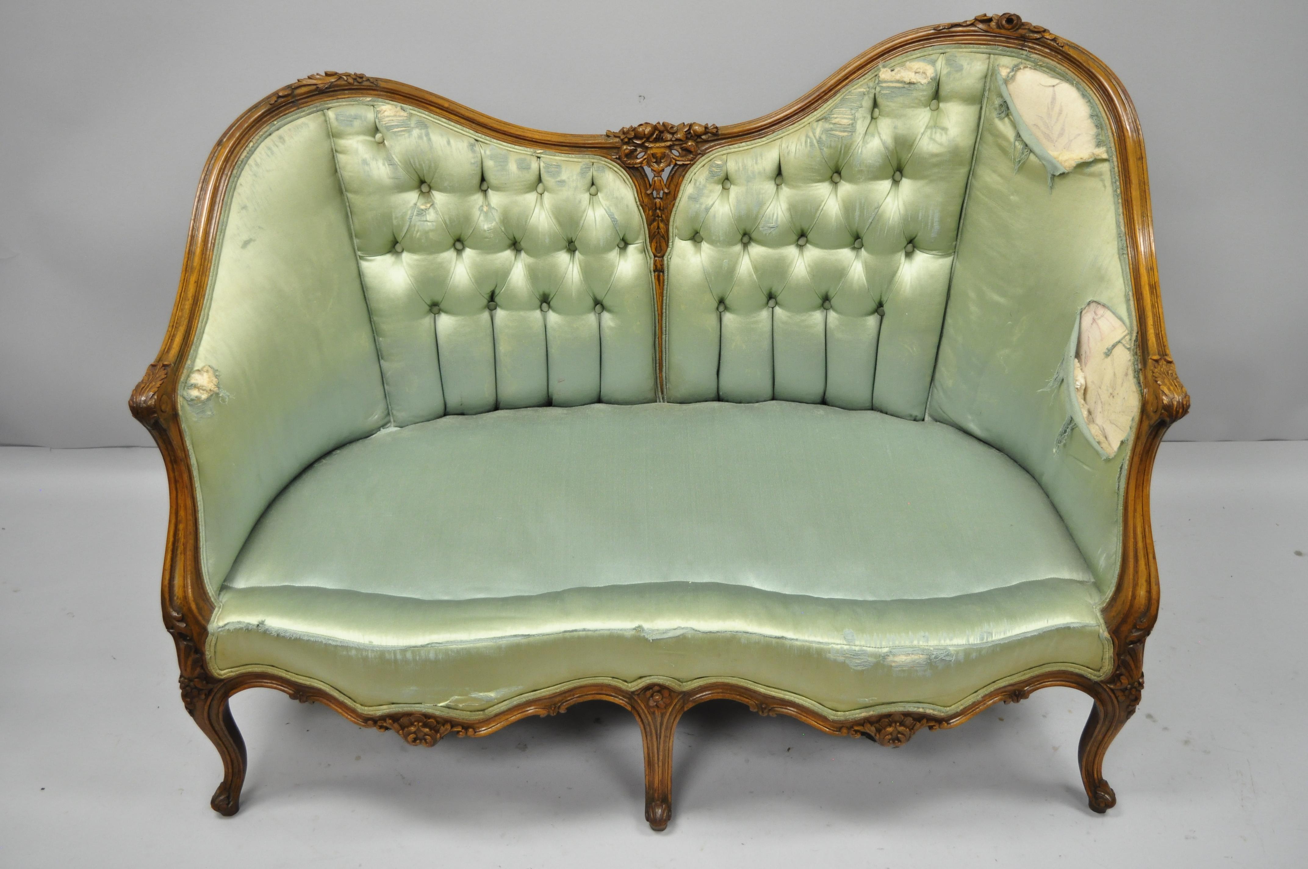 Antique French Louis XV Style carved walnut double hump back settee loveseat. Item features unique double hump back with one end slightly raised, tight solid frame, solid walnut construction, finely carved details, five cabriole legs, and great