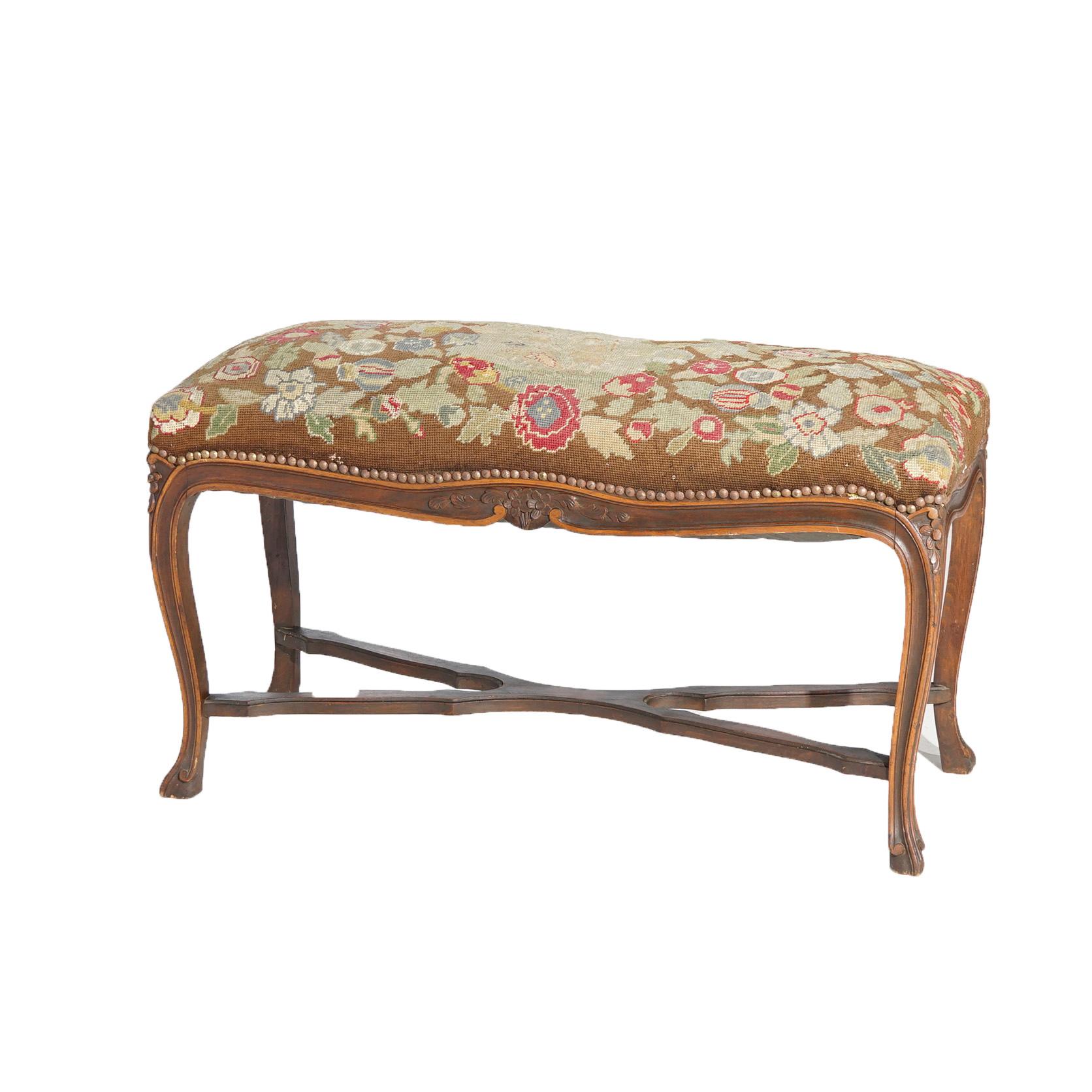 An antique French Louis XV style long bench offers floral tapestry seat with central reserve with courting scene, over carved walnut base having foliate and floral elements and raised on cabriole legs, c1920

Measures- 21.5''H x 37.5''W x 15.25''D.