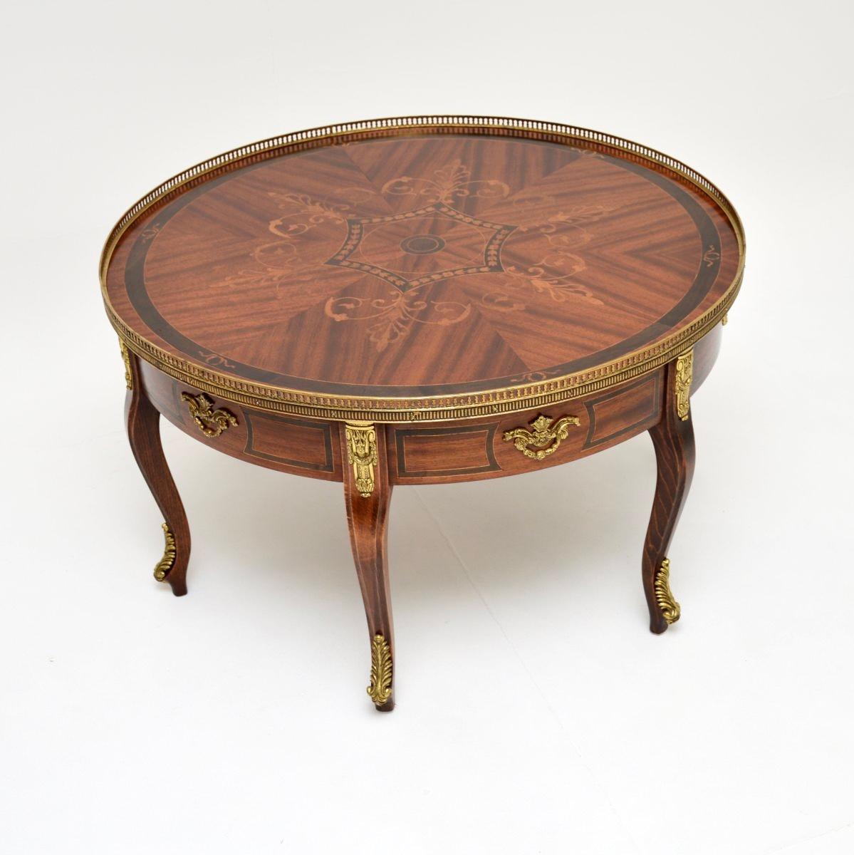 A large and impressive antique French coffee table, dating from around the 1930’s.

This is of exceptional quality, with absolutely gorgeous inlays of various wood, There is a pierced brass gallery and high quality gilt metal mounts, this stands on