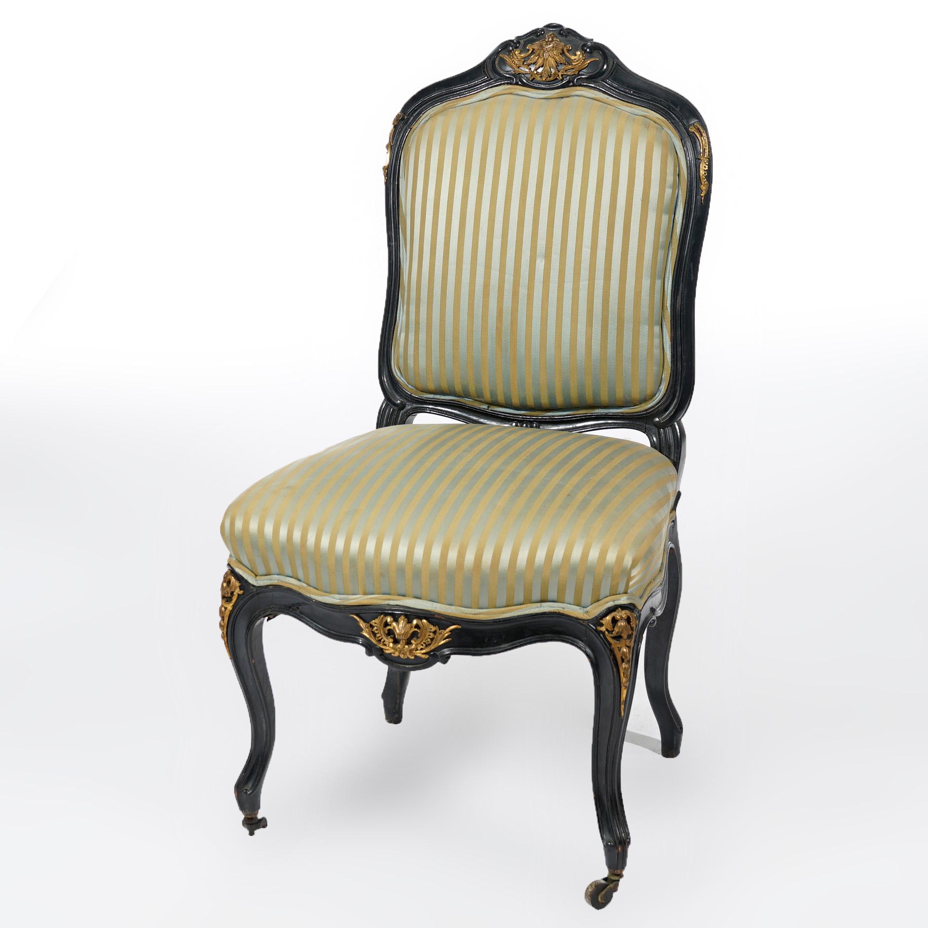 An antique pair of French Louis XV style upholstered side chairs offer ebonized carved wood frame with foliate cast ormolu mounts and stylized scroll form feet, 20th century

Measures- 38''H x 21''W x 22''D

Catalogue Note: Ask about DISCOUNTED