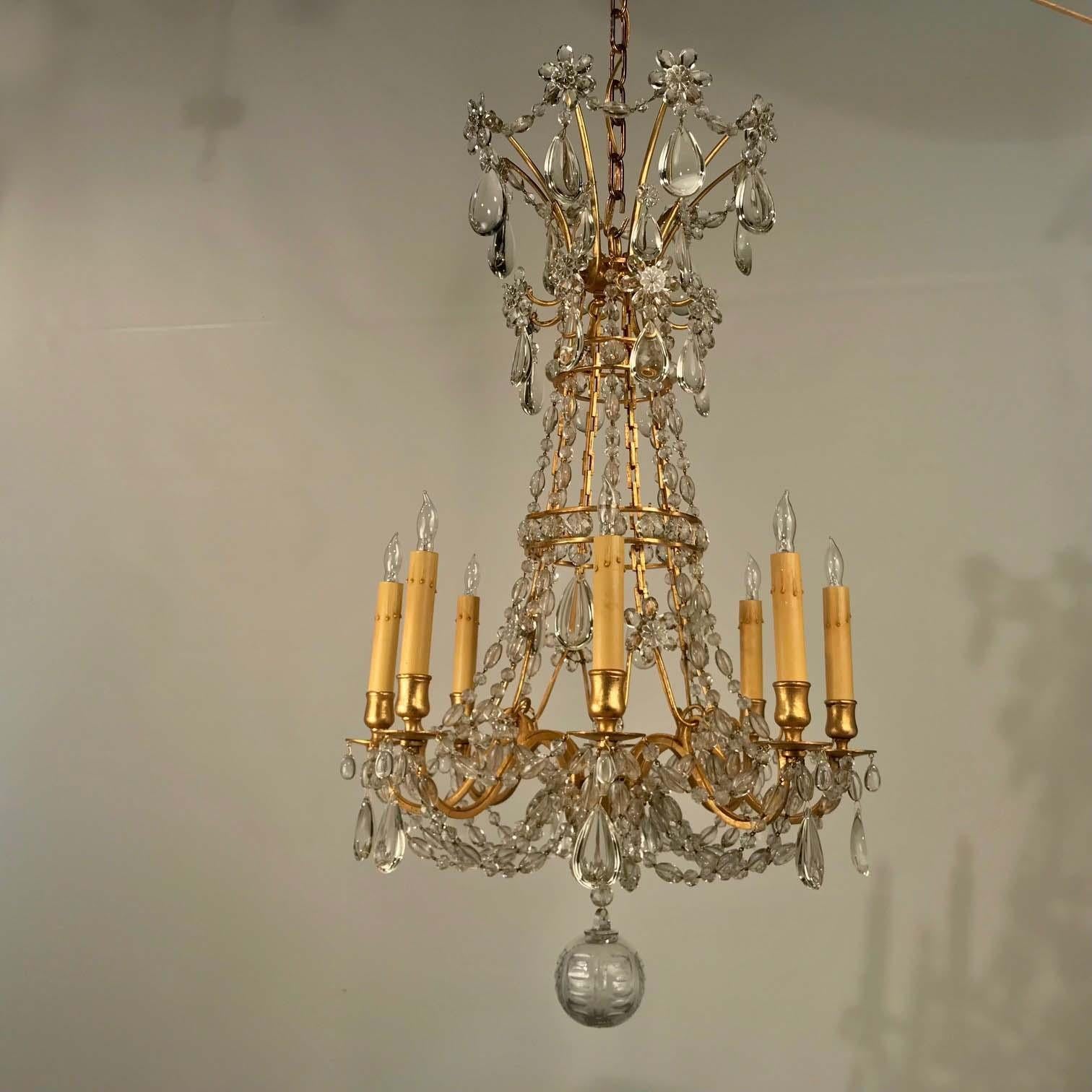 This elegant chandelier has come to us in original condition requiring only careful cleaning and regilding the frame. From the swagged crown to the hand-blown ball, it is hung with a great variety of drops of unusually high quality.