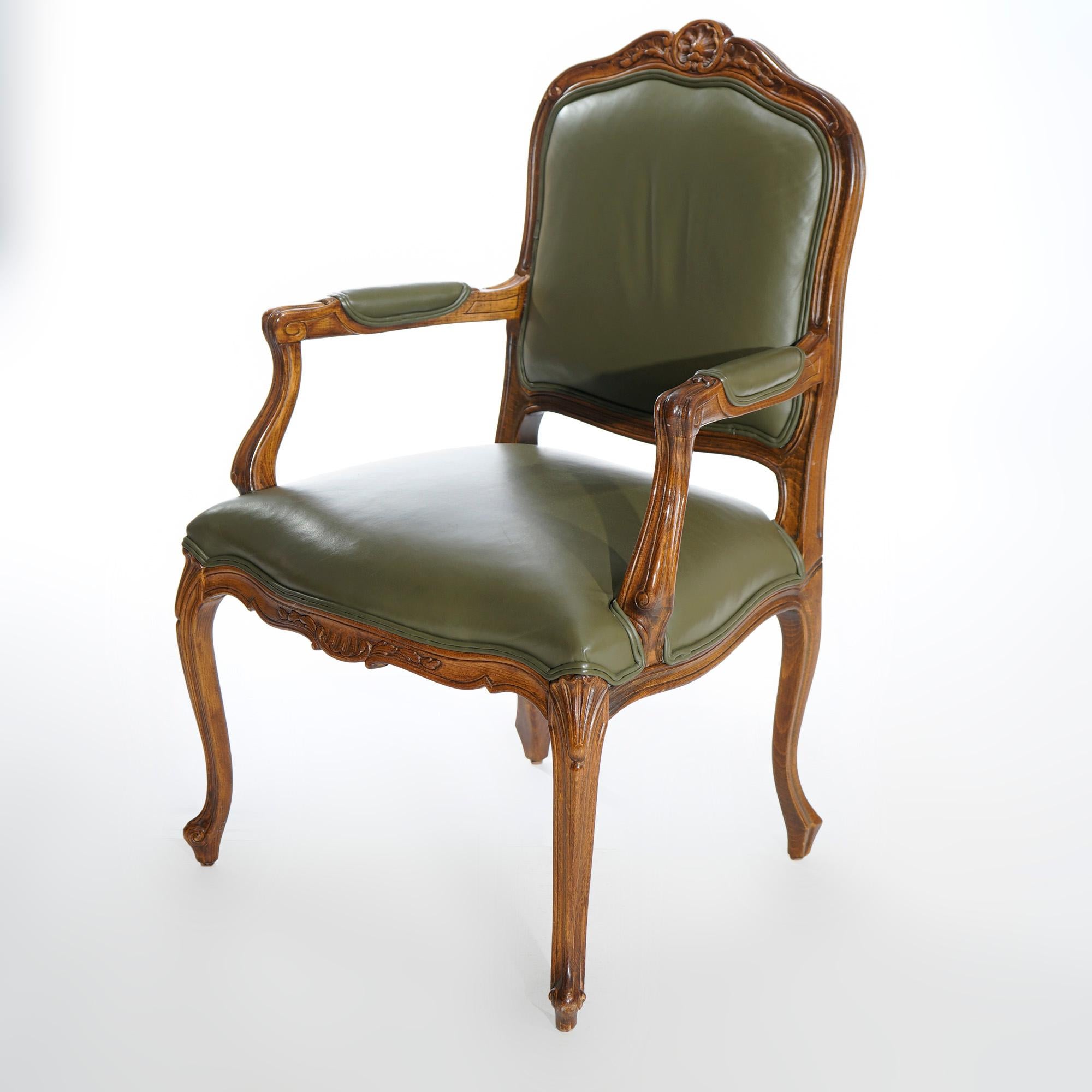 A pair of French Louis XV style fauteuil armchairs by Ethan Allen offer fruitwood frames with crest having carved central shell with flanking foliate elements over upholstered back and seats, covered scroll form arms and raised on cabriole legs,