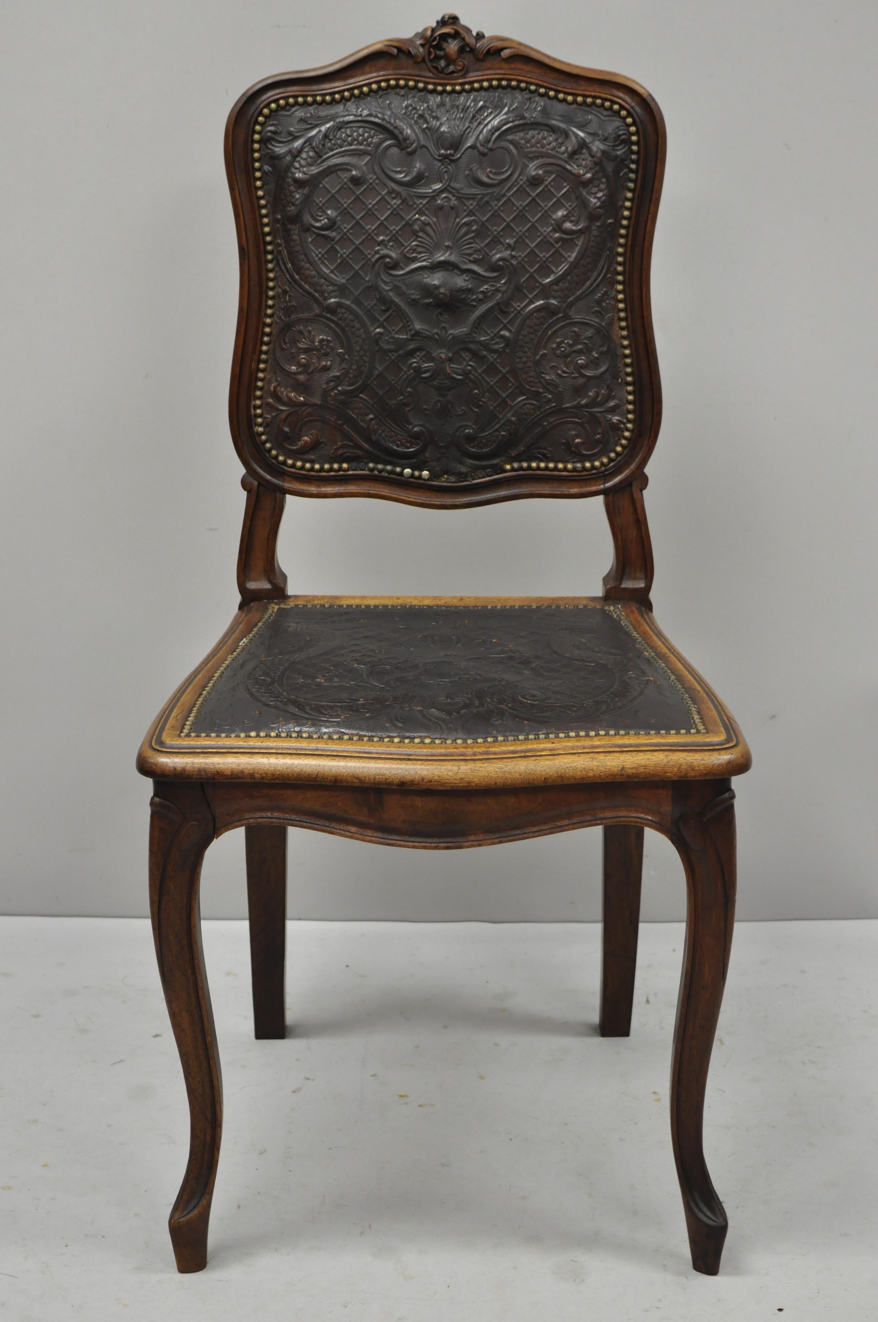 Antique French Louis XV style fancy brown embossed leather walnut side chair (C). Item features brown embossed leather back and seat, nailhead trim, solid wood frame, finely carved details, cabriole legs, very nice antique item, great style and form