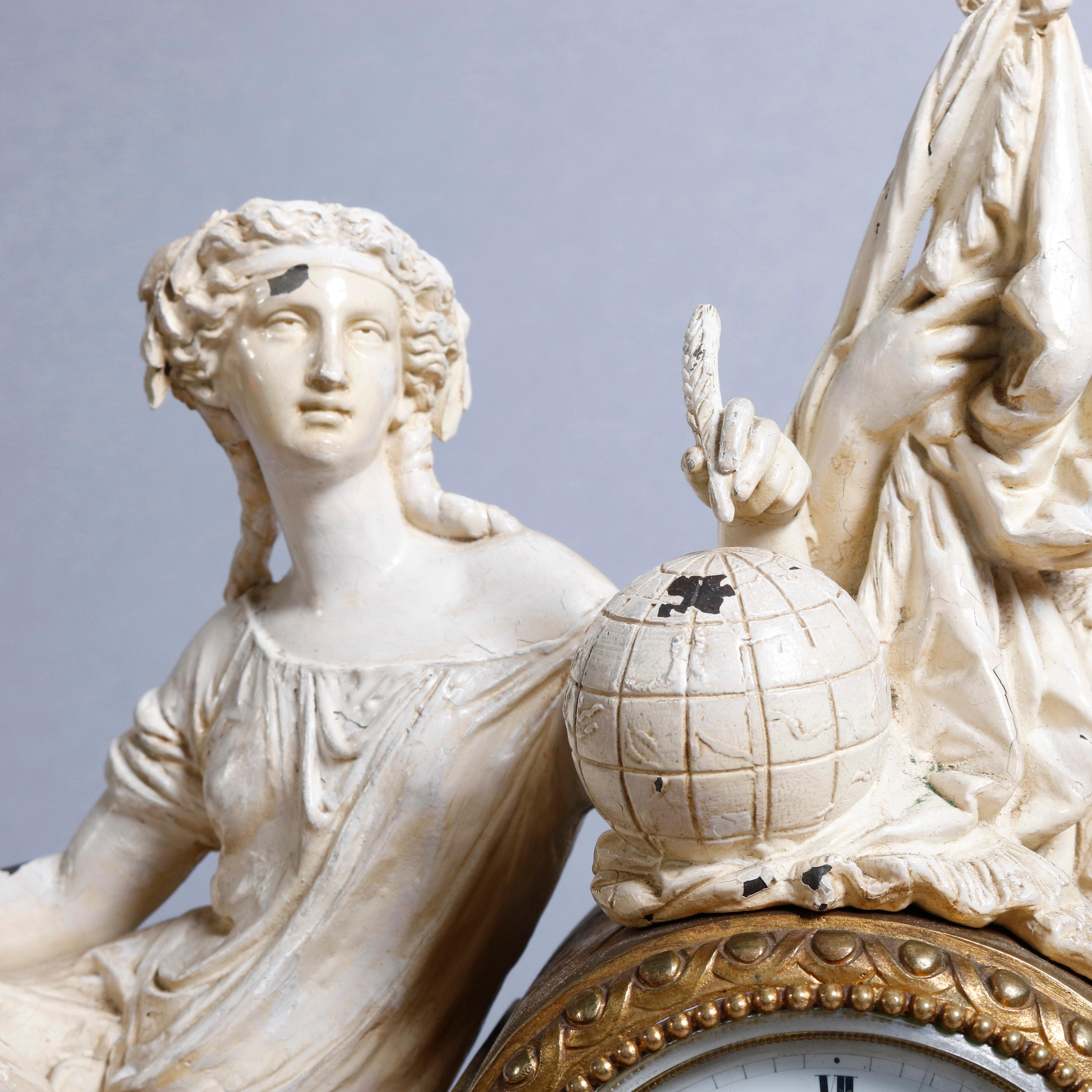 An antique French Louis XV style figural mantel clock offers central dial with Roman numerals flanked by painted white metal statuary including woman with world globe and military man in soldier attire seated on foliate cast bronze and brass base