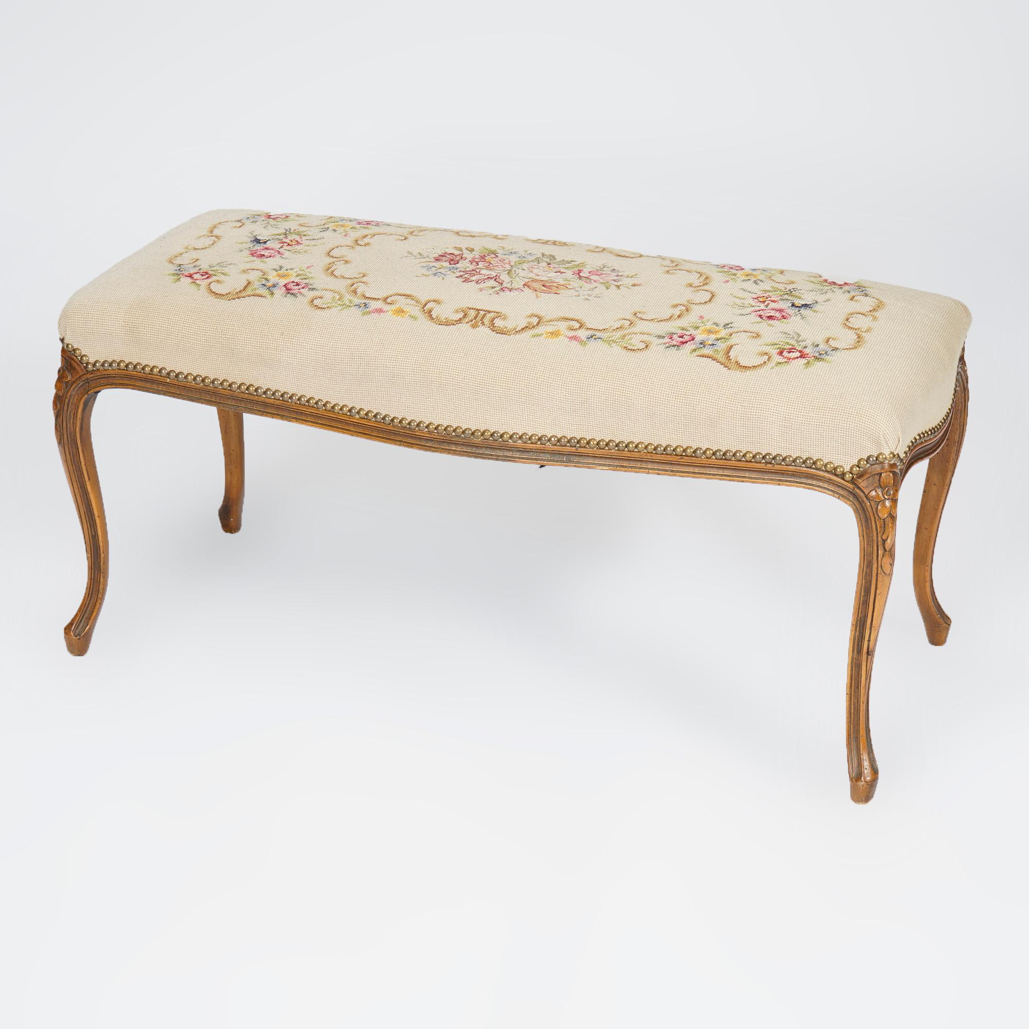 An antique French Louis XV style long bench offers floral needlepoint upholstered seat over fruitwood frame raised on cabriole legs with carved floral knees, c1930

Measures- 18'' H x 37.5'' W x 16.25'' D.

Catalogue Note: Ask about DISCOUNTED