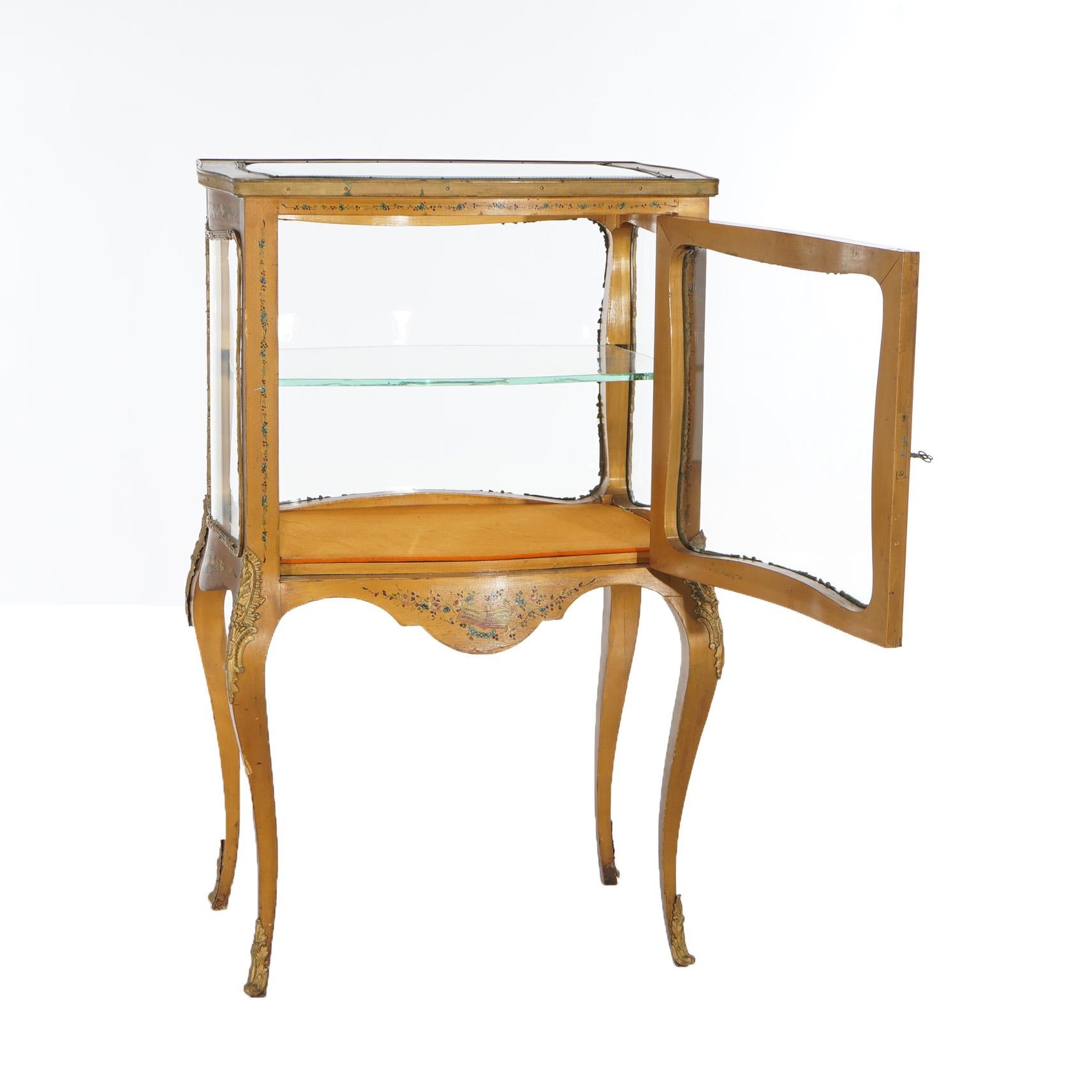 An antique French Louis XV style display vitrine offers giltwood construction with single door opening to shelved interior, hand painted floral elements and raised on cabriole legs, c1910

Measures- 37''H x 23''W x 16''D

Catalogue Note: Ask about