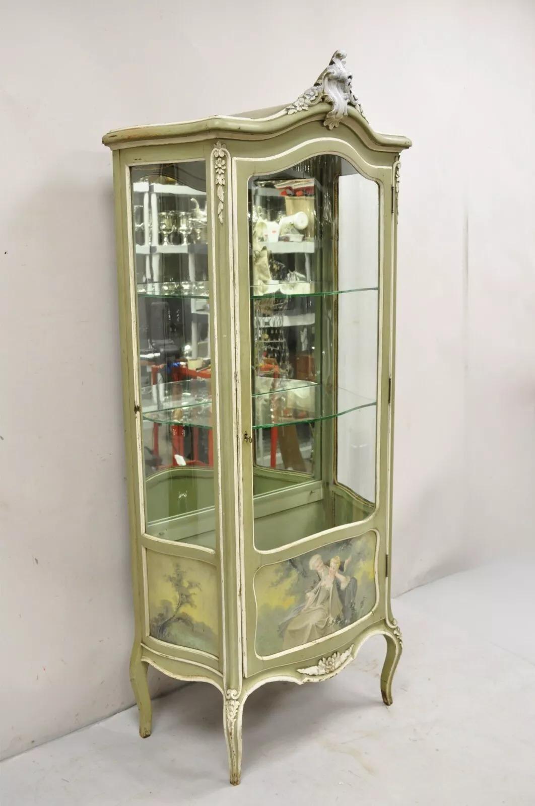 Antique French Louis XV Style Green Distress Painted Curved Glass Curio Cabinet. Item features a mint green and white painted finish with painted scenes to the lower portion. Item further features 3 curved glass panels and 2 glass shelves with