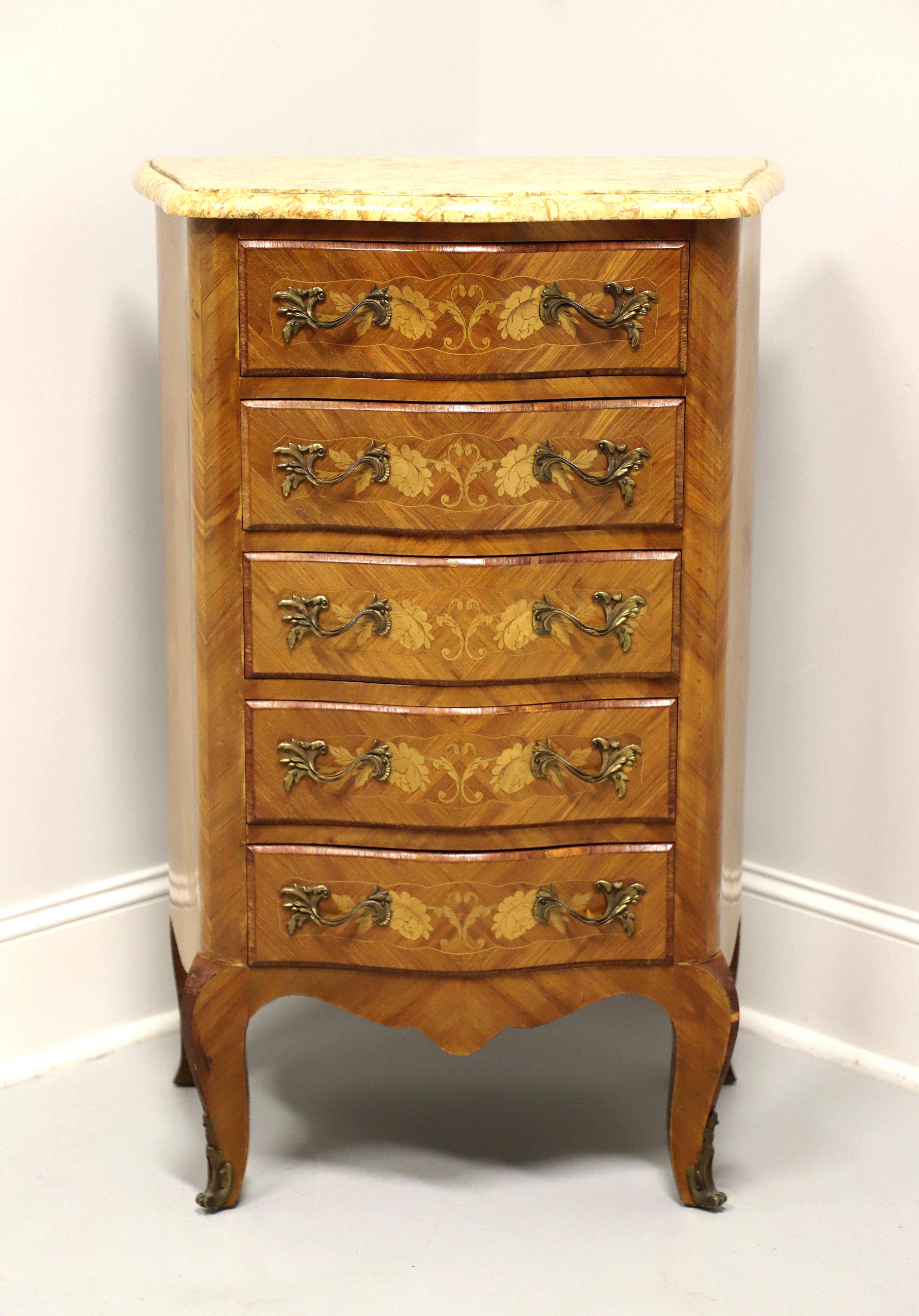 An antique semainier chest in the French Louis XV style, unbranded. Constructed of kingwood with a bowed front, inlaid floral designs on the drawer fronts, brass drawer pulls, cream color marble top, and brass ormolu on the feet. Features five