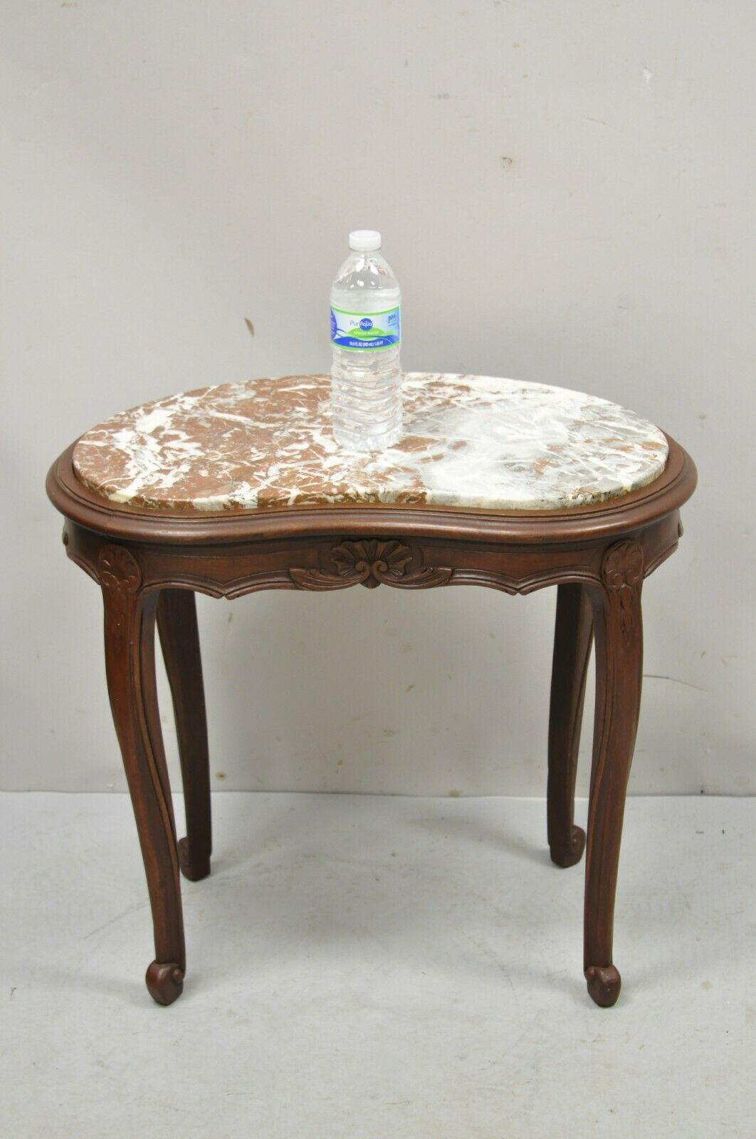 Antique French Louis XV style marble top kidney shaped small coffee table. Item features an inset kidney shaped marble top, solid wood frame, nicely carved details, original label, cabriole legs. Circa Early 1900s. Measurements: 21